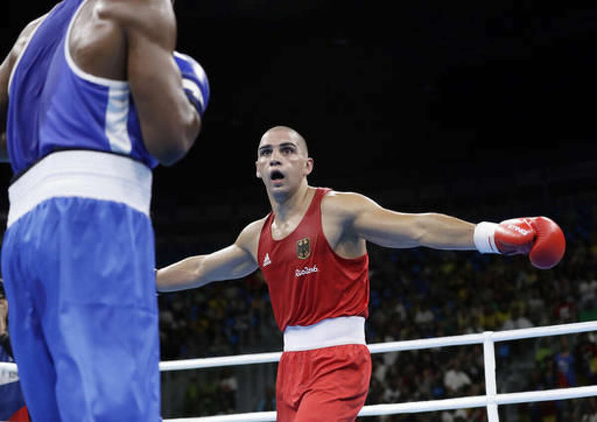 Germany's Serge Michel gestures as he fights Ecuador's Carlos Andres Mina during a men's light heavyweight 81-kg preliminary boxing match at the 2016 Summer Olympics in Rio de Janeiro, Brazil, Sunday, Aug. 7, 2016. (AP Photo/Frank Franklin II)