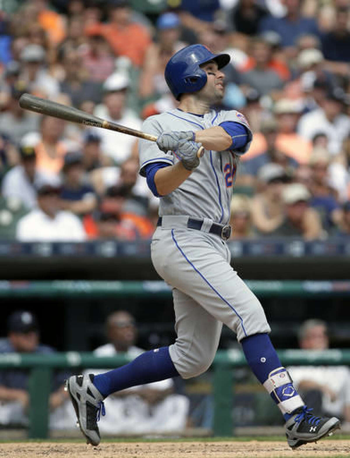 New York Mets' Neil Walker hits a two-run home run against the Detroit Tigers during the ninth inning of an interleague baseball game Sunday, Aug. 7, 2016, in Detroit. (AP Photo/Duane Burleson)