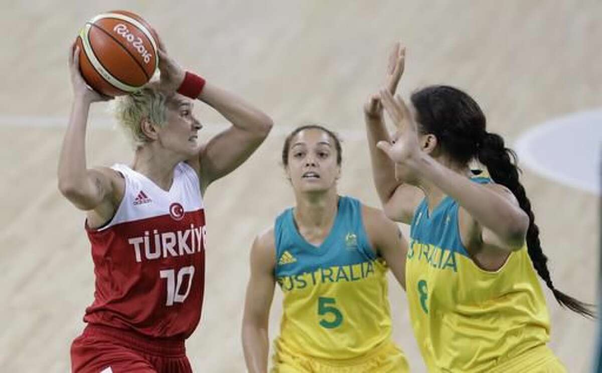 Turkey guard Isil Alben looks to shoot over the defense of Australia center Liz Cambage (8) during the first half of a women's basketball game at the Youth Center at the 2016 Summer Olympics in Rio de Janeiro, Brazil, Sunday, Aug. 7, 2016. (AP Photo/Carlos Osorio)