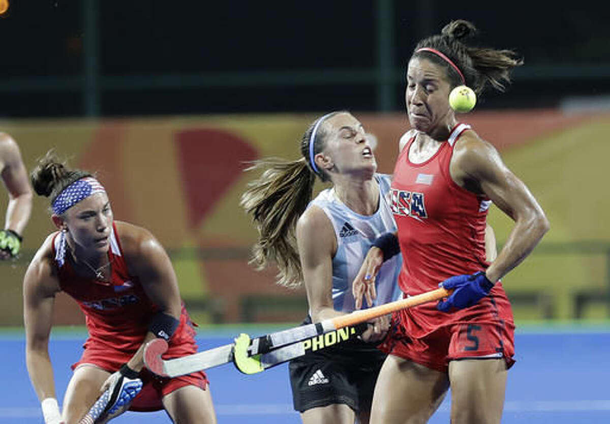 United States' Melissa Gonzalez, right, challenges with Argentina's Carla Rebecchi, center, during a women's field hockey match at 2016 Summer Olympics in Rio de Janeiro, Brazil, Saturday, Aug. 6, 2016. (AP Photo/Hussein Malla)