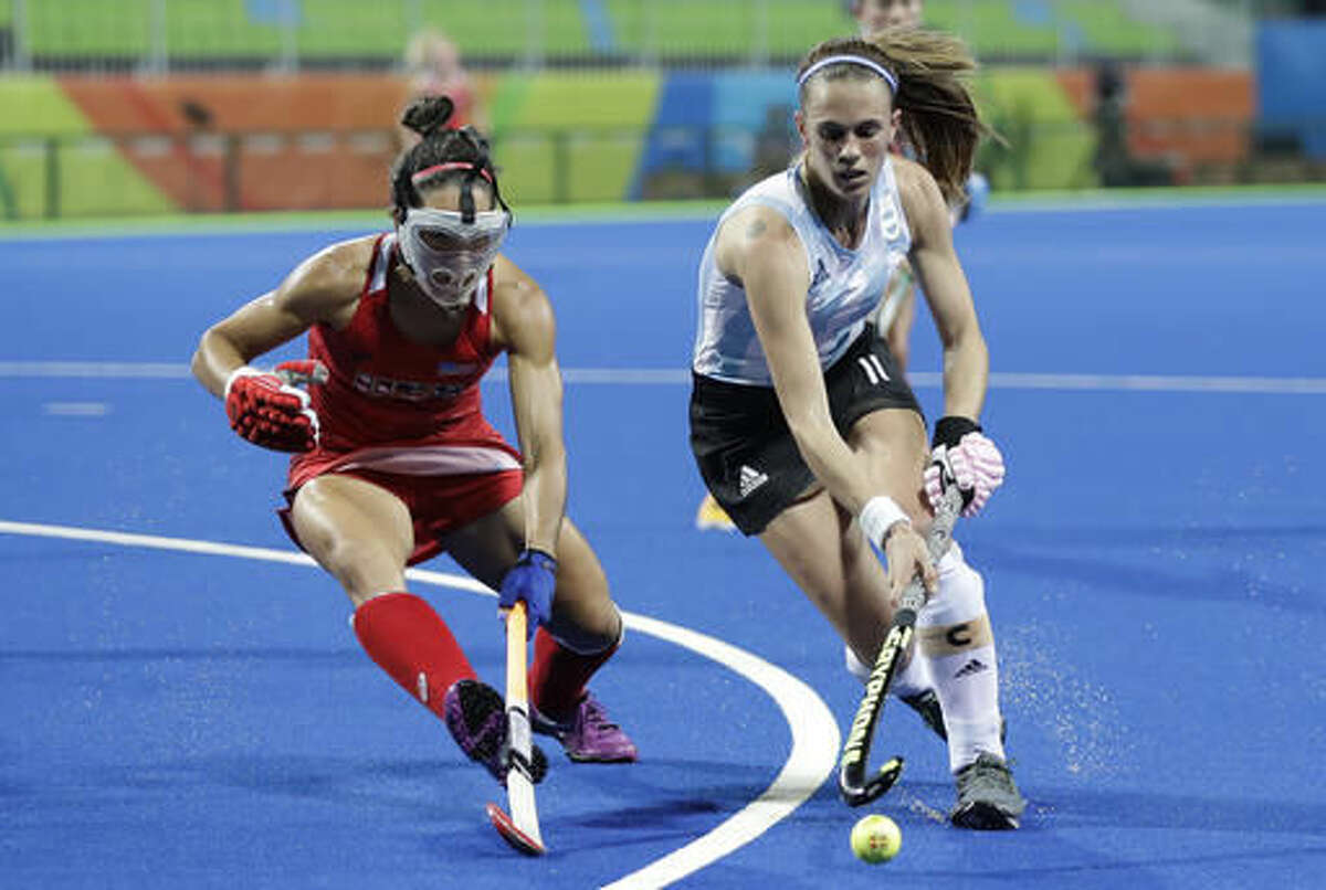 Argentina's Carla Rebecchi, right, fight for the ball with United States' Melissa Gonzalez, left, during a women's field hockey match at 2016 Summer Olympics in Rio de Janeiro, Brazil, Saturday, Aug. 6, 2016. (AP Photo/Hussein Malla)