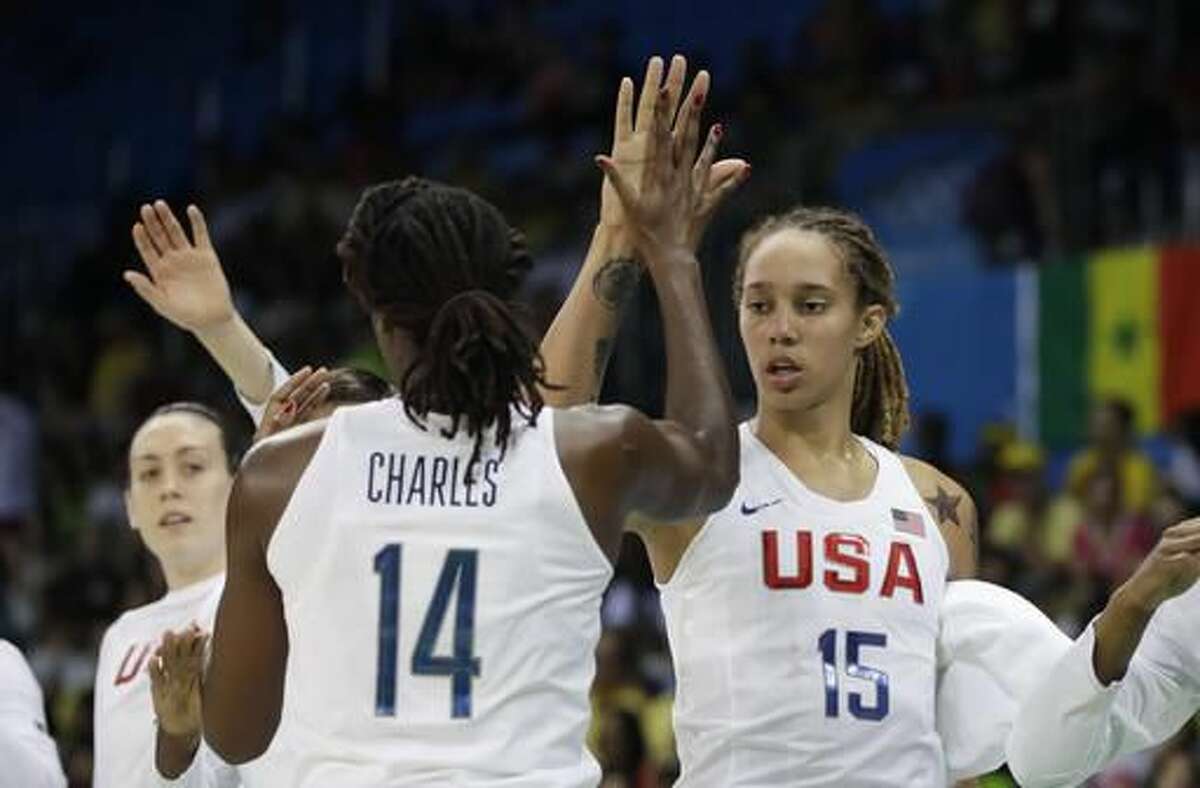 United States center Tina Charles is congratulated by center Brittney Griner during a timeout during the first half of a women's basketball game against Senegal at the Youth Center at the 2016 Summer Olympics in Rio de Janeiro, Brazil, Sunday, Aug. 7, 2016. (AP Photo/Carlos Osorio)