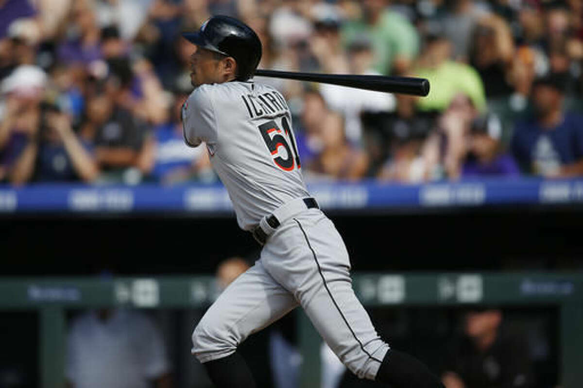 Miami Marlins' Ichiro Suzuki follows the flight of his triple off Colorado Rockies starting pitcher Chris Rusin in the seventh inning of a baseball game, Sunday, Aug. 7, 2016 in Denver. The hit was the 3,000th in his Major League career. (AP Photo/David Zalubowski)