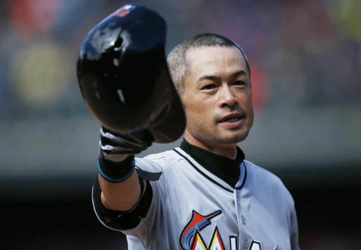 Miami Marlins' Ichiro Suzuki tips his batting helmet to the crowd as fans applaud after he hit a triple off Colorado Rockies relief pitcher Chris Rusin in the seventh inning of a baseball game, Sunday, Aug. 7, 2016 in Denver. The hit was the 3,000th in his Major League career. (AP Photo/David Zalubowski)