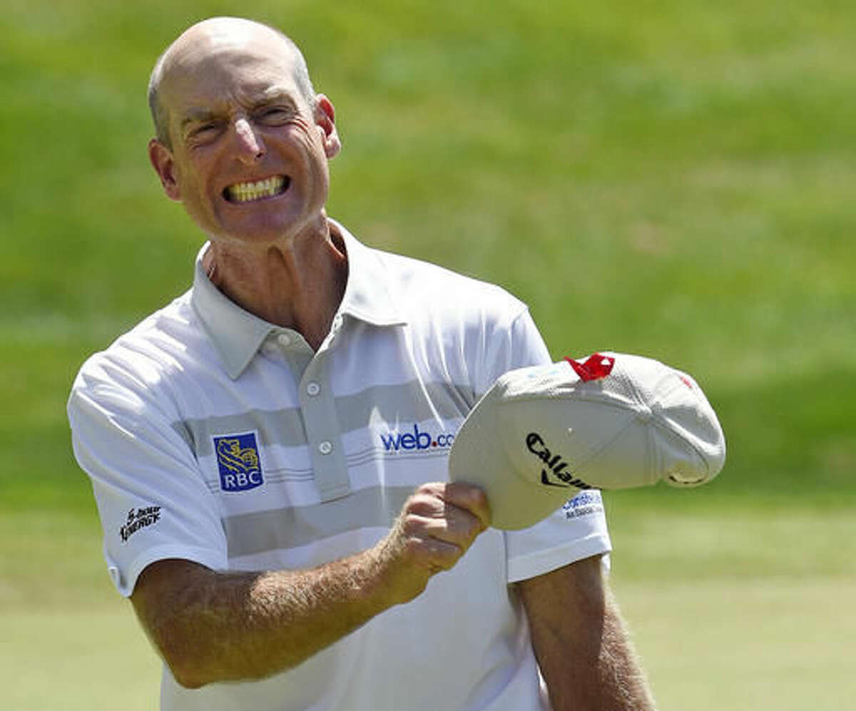 Jim Furyk celebrates after shooting a course and PGA-record 58 during the final round of the Travelers Championship golf tournament in Cromwell, Conn., Sunday, Aug. 7, 2016. (AP Photo/Fred Beckham)