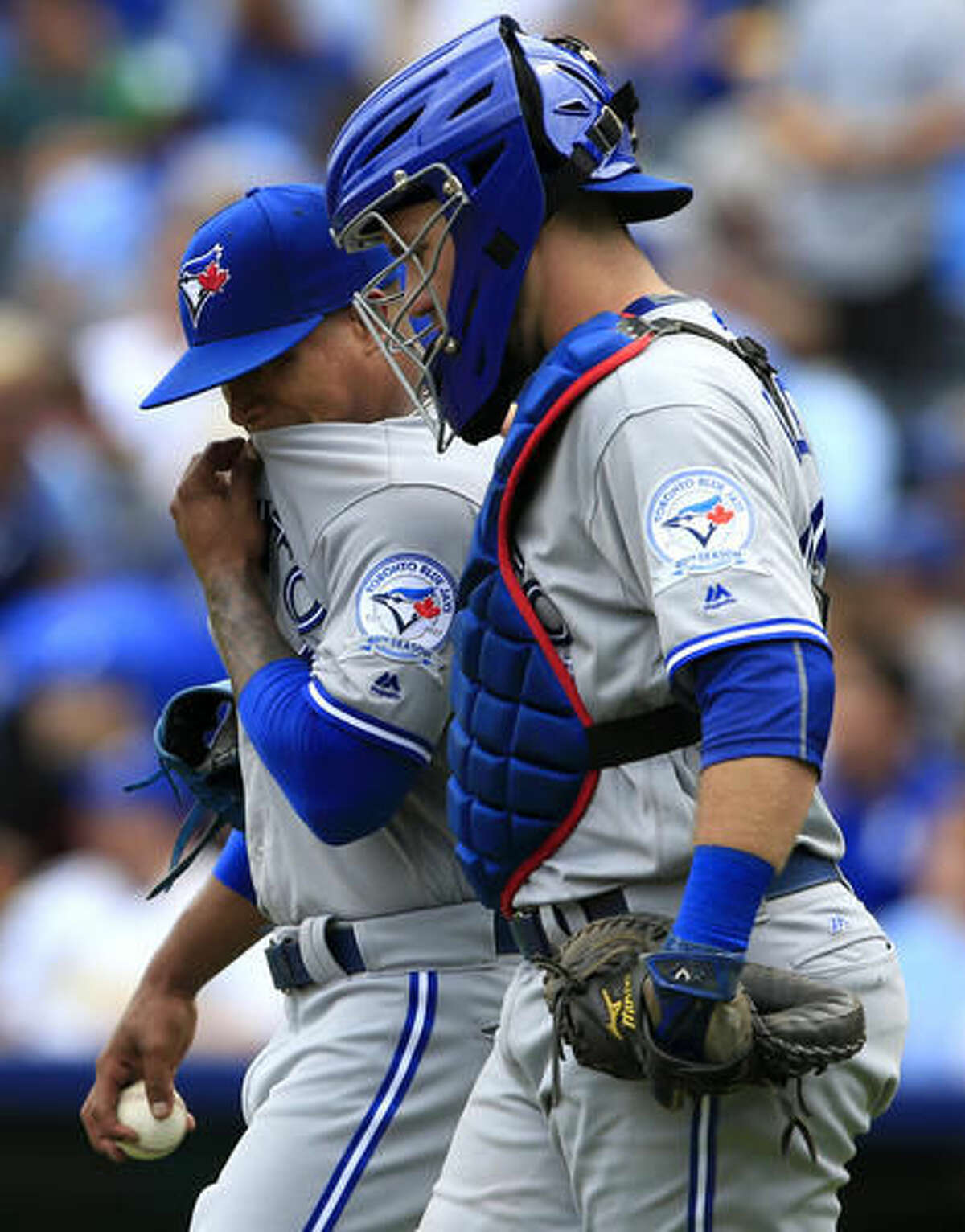 Toronto Blue Jays starting pitcher Marcus Stroman, left, talks with catcher Josh Thole, right, after allowing a run in the second inning of a baseball game against the Kansas City Royals in Kansas City, Mo., Sunday, Aug. 7, 2016. (AP Photo/Orlin Wagner)