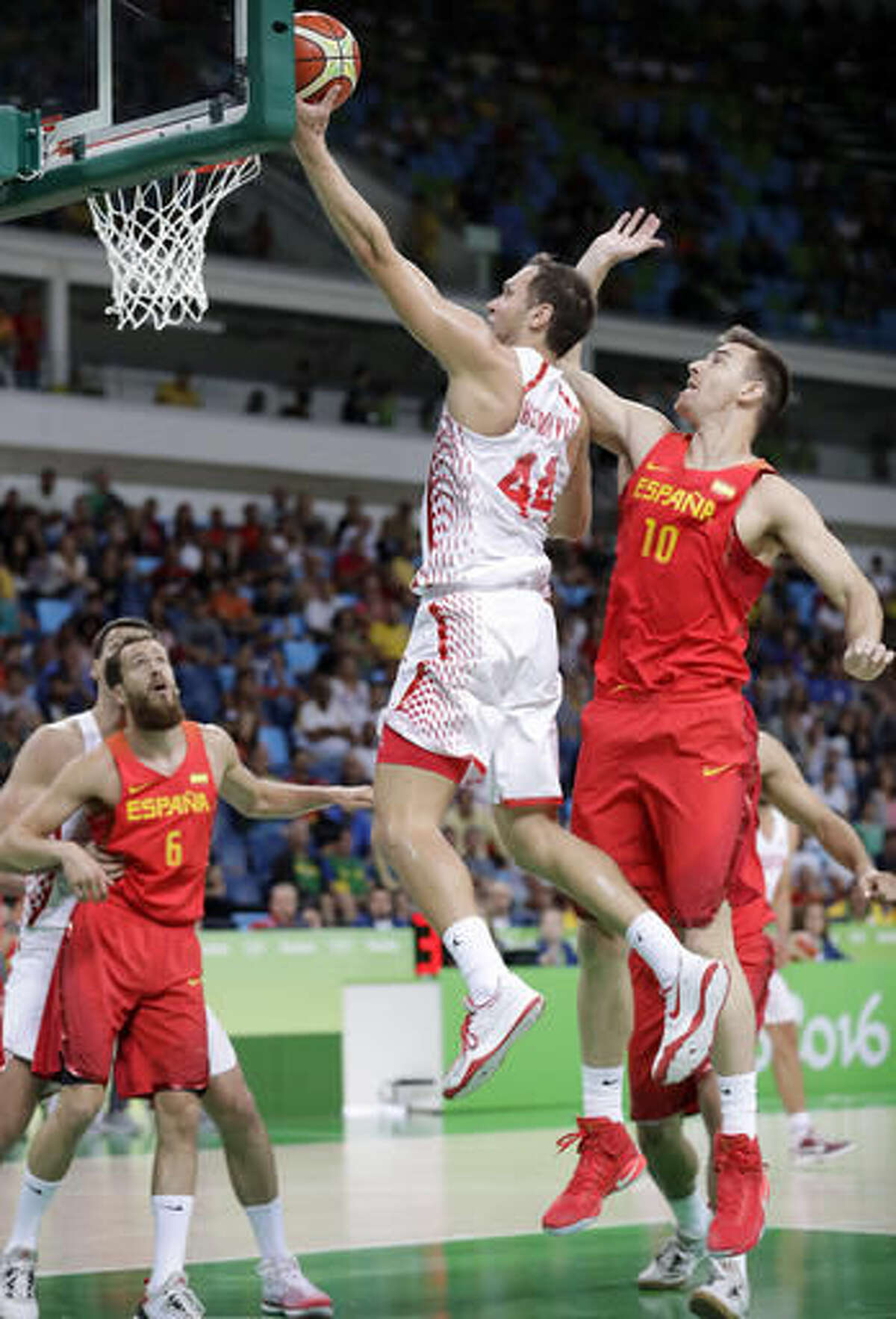 Croatia's Bojan Bogdanovic (44) drives to the basket past Spain's Victor Claver (10) during a basketball game at the 2016 Summer Olympics in Rio de Janeiro, Brazil, Sunday, Aug. 7, 2016. (AP Photo/Charlie Neibergall)