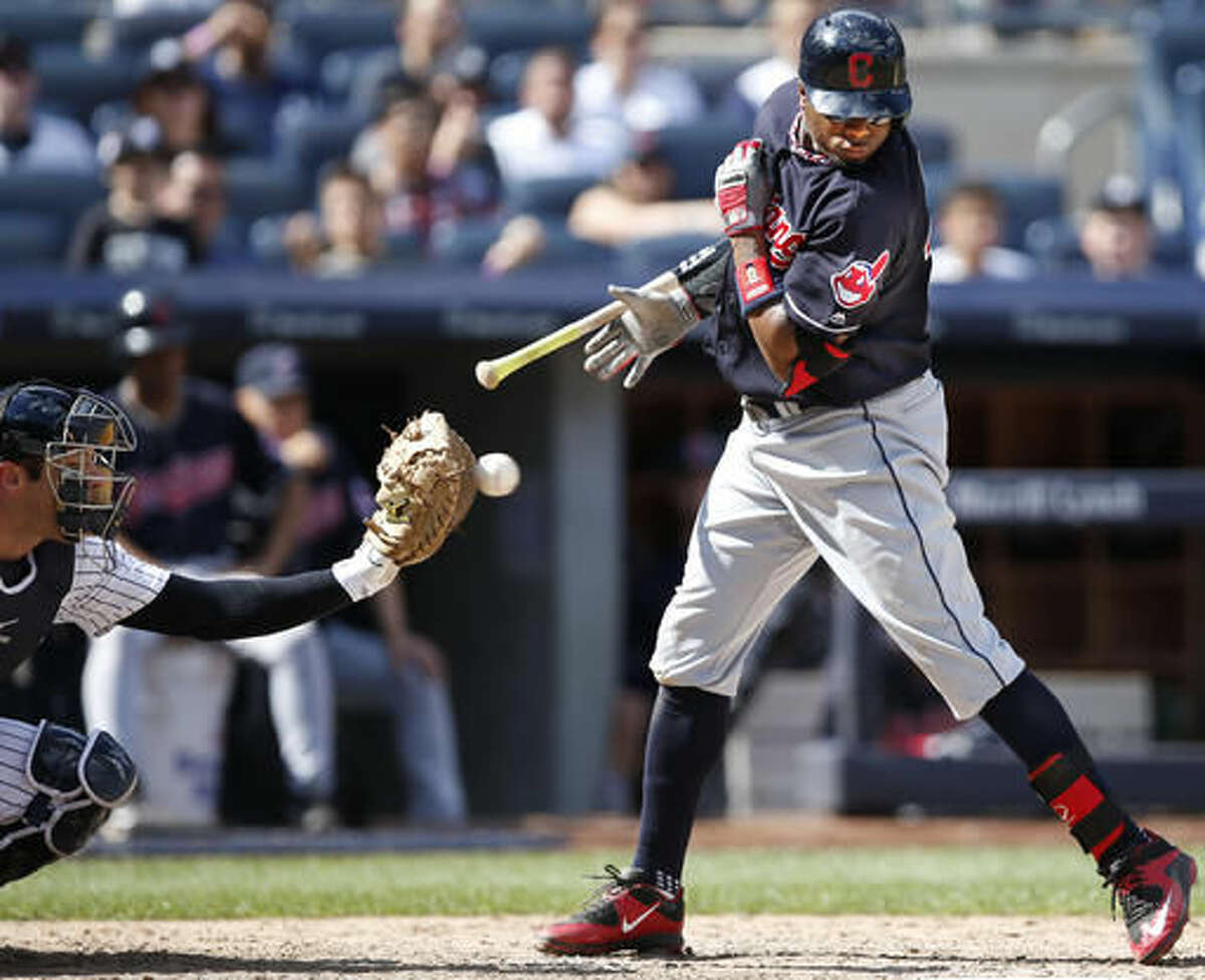 New York Yankees catcher Austin Romine, left, reaches for the ball as Cleveland Indians batter Rajai Davis rears back and loses his bat on a eighth-inning walk in a baseball game in New York, Sunday, Aug. 7, 2016. (AP Photo/Kathy Willens)