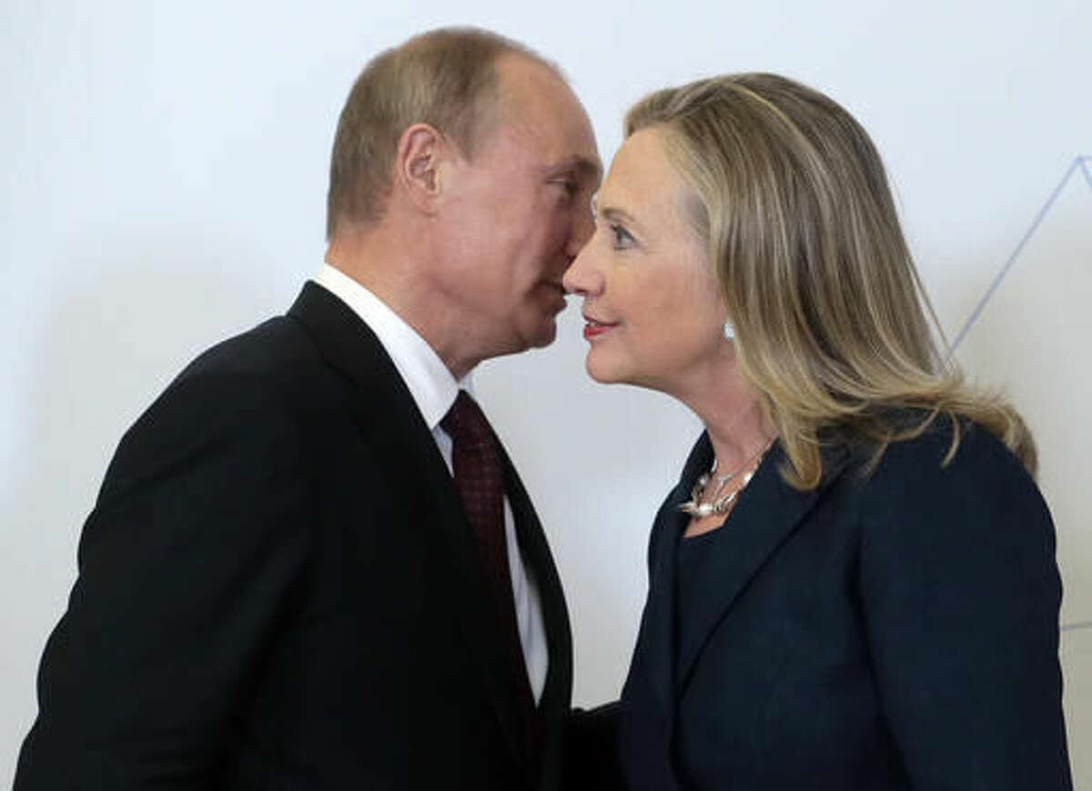 FILE - In this Sept. 8, 2012 pool-file photo, Russian President Vladimir Putin meets with then-Secretary of State Hillary Clinton in Vladivostok, Russia. Clinton says as president she will stand up to Putin. As secretary of state, her wrangles with Russia had mixed results. Clinton, the public face of President Barack Obama's first-term "reset" policy with Russia, scored a number of diplomatic successes _ when Dmitry Medvedev was president. When Putin reclaimed the presidency, it was a different story. (AP Photo/Mikhail Metzel, Pool, File)