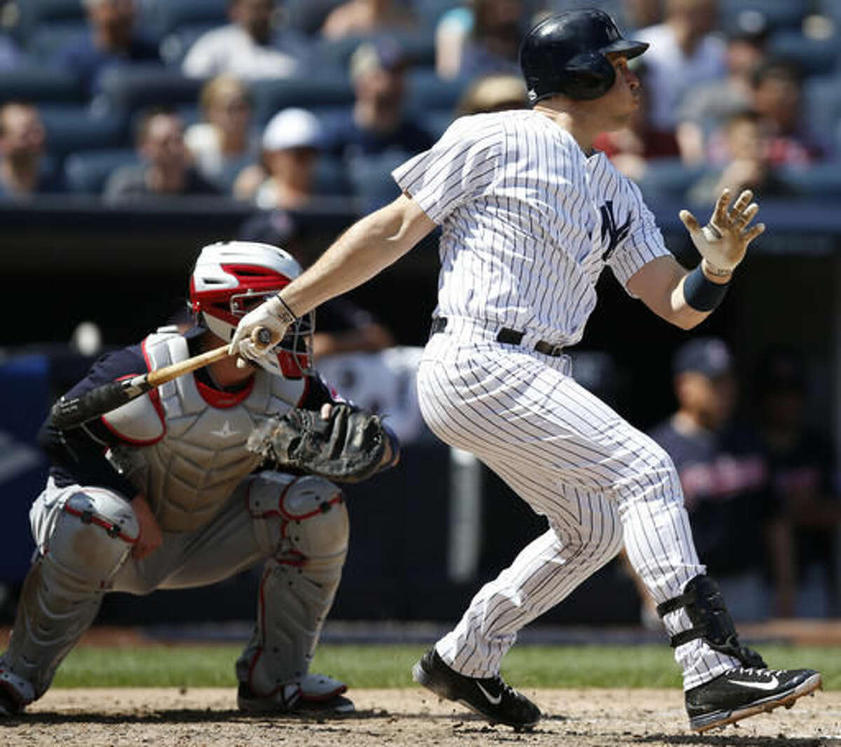 New York Yankees' Mark Teixeira, right, hits a fifth-inning double in a baseball game against the Cleveland Indians, in New York, Sunday, Aug. 7, 2016. Indians catcher Roberto Perez looks on. (AP Photo/Kathy Willens)