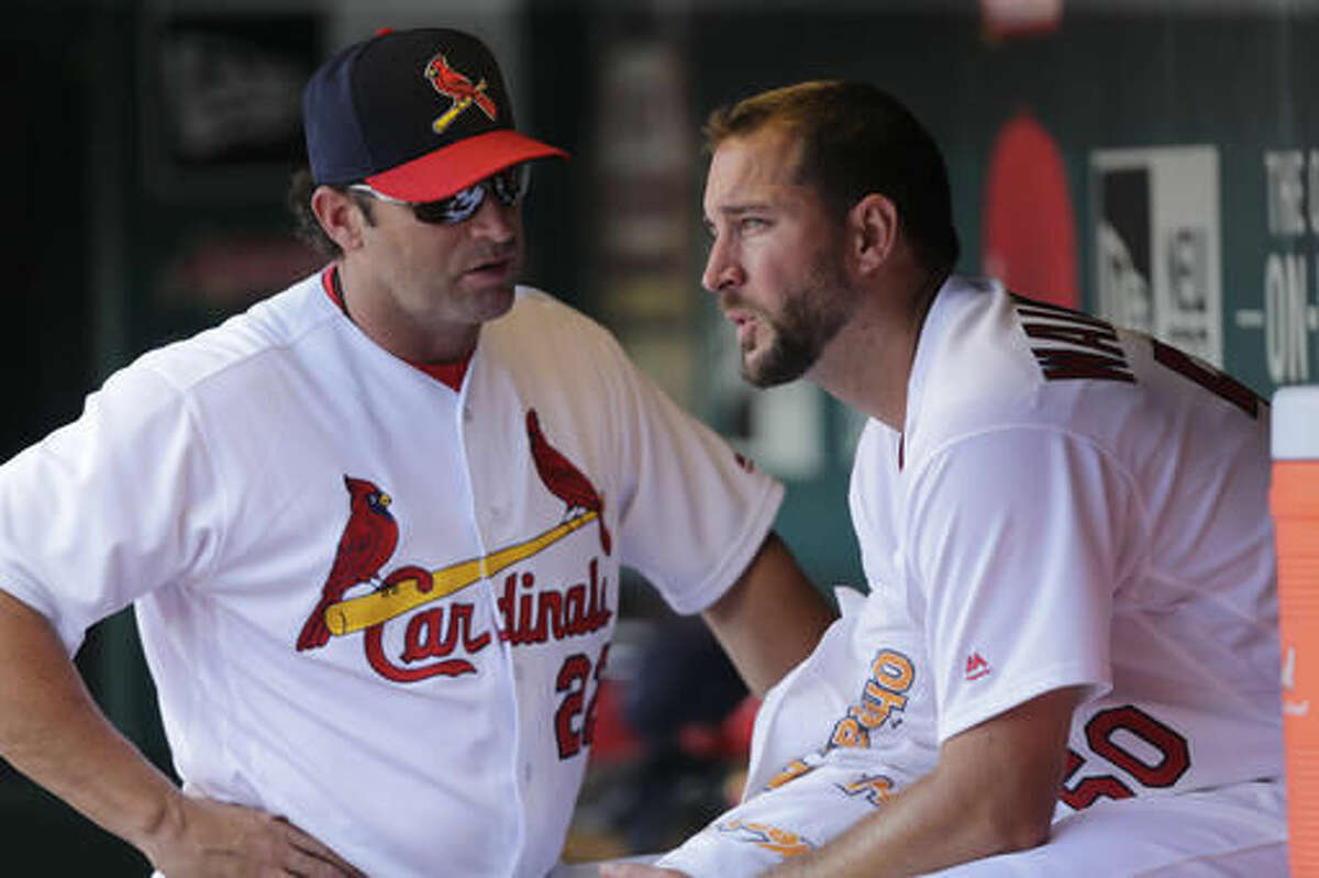 St. Louis Cardinals manager Mike Matheny (22) talks with starting pitcher Adam Wainwright (50), after Wainwright gave up three runs in each of the first two innings, in the second inning of a baseball game against the Atlanta Braves, Sunday, Aug. 7, 2016, in St. Louis. (AP Photo/Tom Gannam)