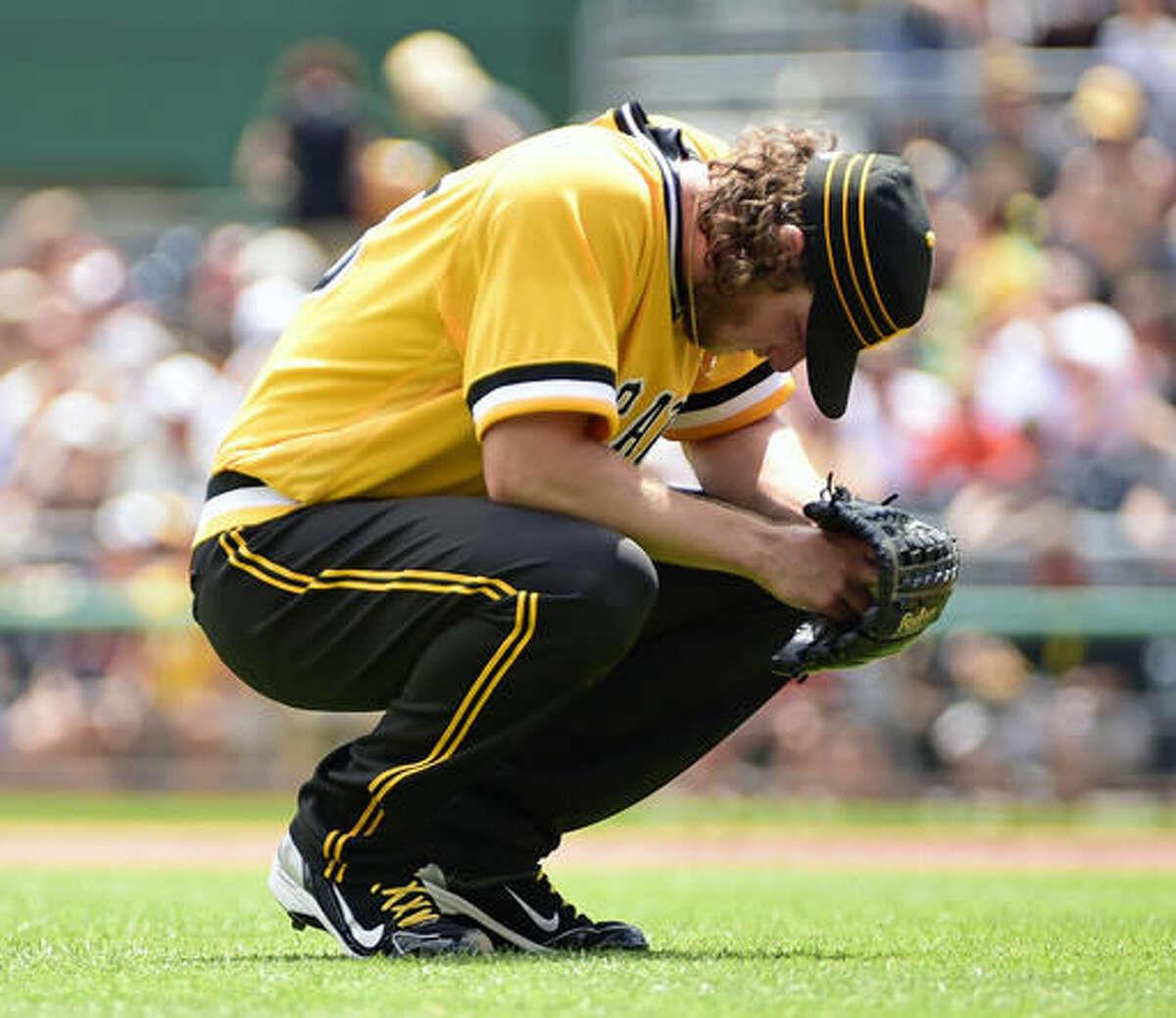 Pittsburgh Pirates starting pitcher Gerrit Cole takes a break as umpires review a call in the first inning of a baseball game against the Cincinnati Reds in Pittsburgh, Sunday, Aug. 7, 2016. (AP Photo/Fred Vuich)