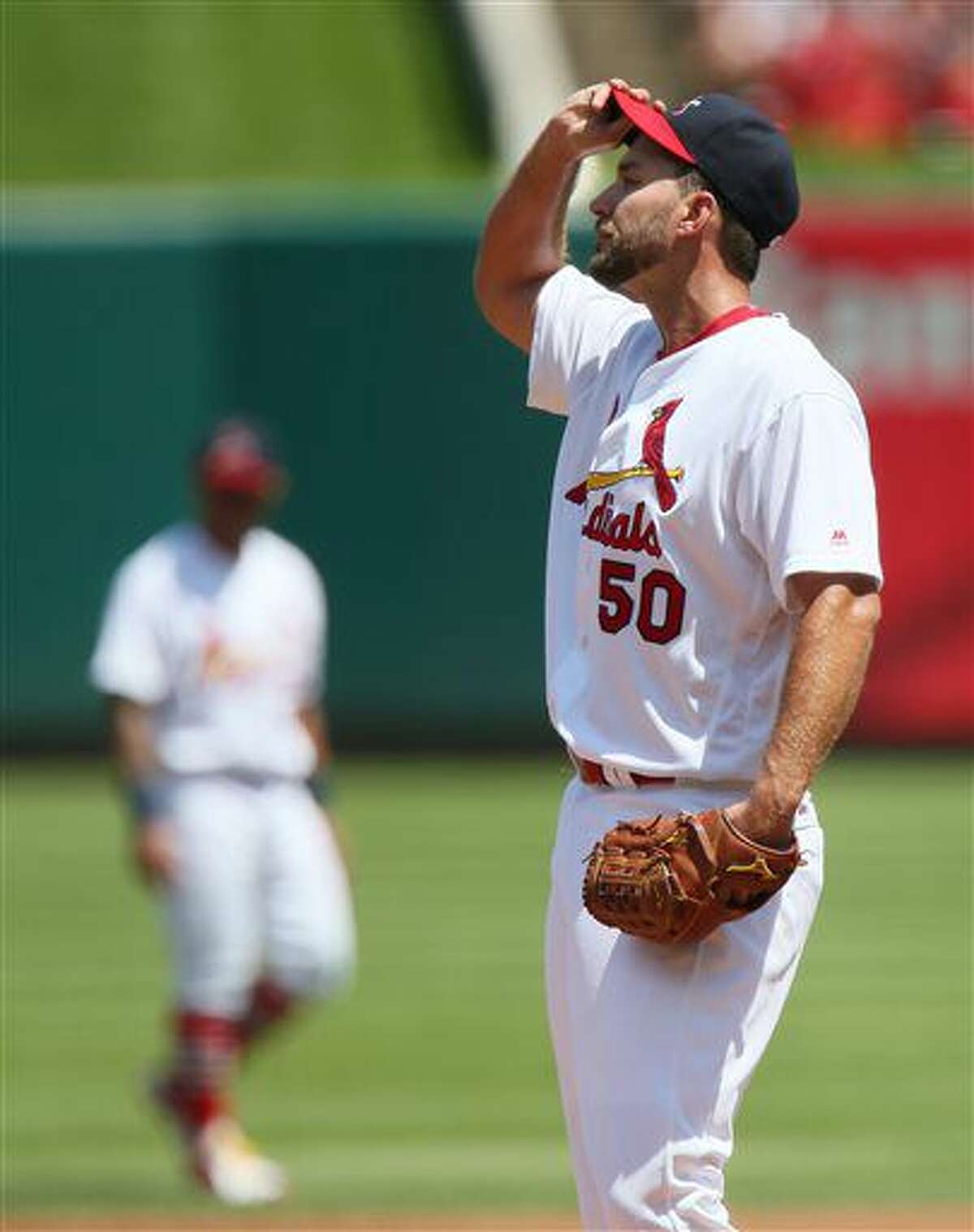 St. Louis Cardinals starting pitcher Adam Wainwright reacts after allowing a two-run single to Atlanta Braves' Nick Markakis in the first inning of a baseball game against the Atlanta Braves on Sunday, Aug. 7, 2016, in St. Louis. (Chris Lee/St. Louis Post-Dispatch via AP)
