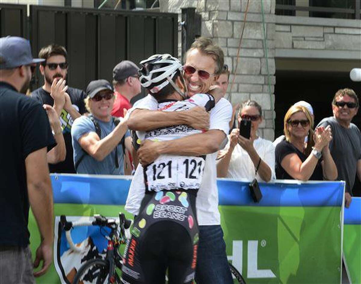 Lachlan Morton, of Jelly Belly Racing & pb Maxxis, gets a hug from his support team at the finish line after winning the Tour of Utah, Sunday, Aug. 7, 2016. (Scott Sommerdorf/The Salt Lake Tribune via AP)