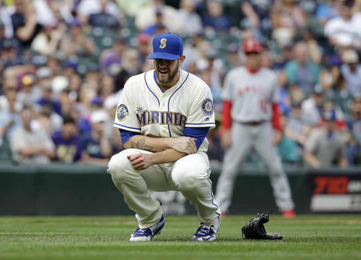 Seattle Mariners starting pitcher James Paxton holds his left arm after being hit by a line drive against the Los Angeles Angels in the ninth inning of a baseball game Sunday, Aug. 7, 2016, in Seattle. Paxton left the game. (AP Photo/Elaine Thompson)