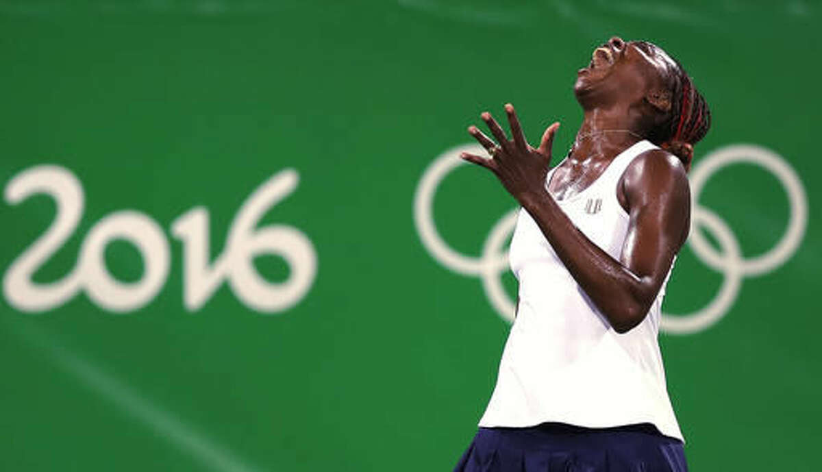 Venus Williams, of the United States, reacts after losing a point in a doubles match with her sister Serena against Lucie Safarova and Barbora Strycova, of the Czech Republic, at the 2016 Summer Olympics in Rio de Janeiro, Brazil, Sunday, Aug. 7, 2016. (AP Photo/Charles Krupa)