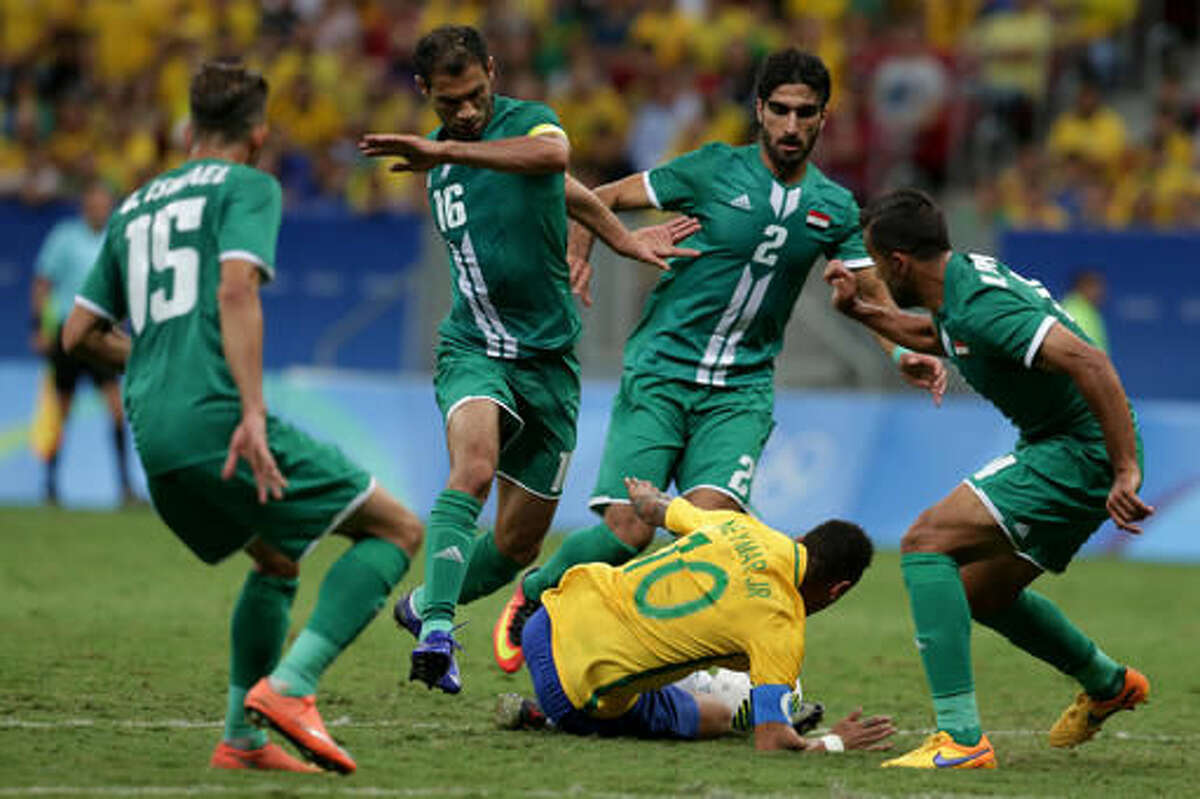 Brazil's Neymar, bottom, falls to the field surrounded by Iraq players during a group A match of the men's Olympic football tournament between Brazil and Iraq at the National Stadium in Brasilia, Brazil, Sunday, Aug. 7, 2016. (AP Photo/Eraldo Peres)