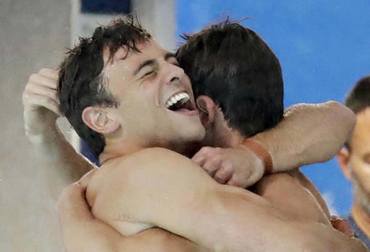 Britain's Tom Daley, left, and Daniel Goodfellow celebrate winning bronze after their final dive during the men's synchronized 10-meter platform diving final in the Maria Lenk Aquatic Center at the 2016 Summer Olympics in Rio de Janeiro, Brazil, Monday, Aug. 8, 2016. (AP Photo/Matt Dunham)