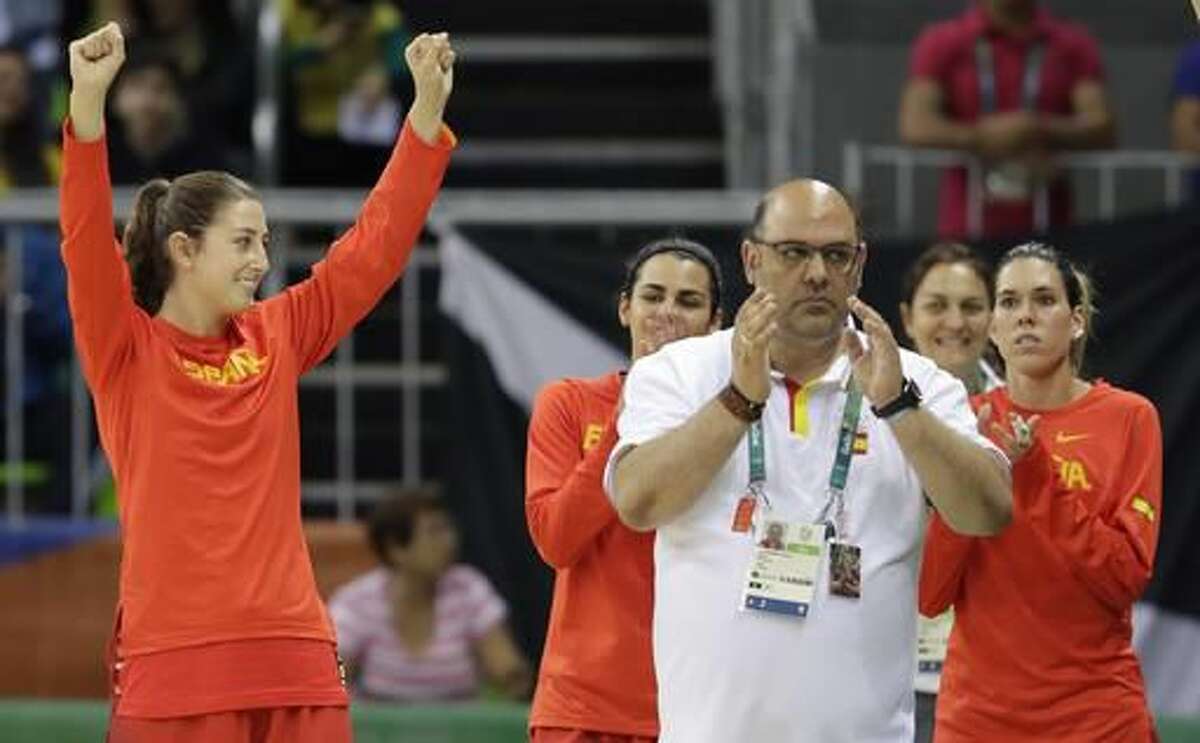 Spain head coach Lucas Mondelo and team celebrate their 89-68 win over China in a women's basketball game against China at the Youth Center at the 2016 Summer Olympics in Rio de Janeiro, Brazil, Wednesday, Aug. 10, 2016. (AP Photo/Carlos Osorio)