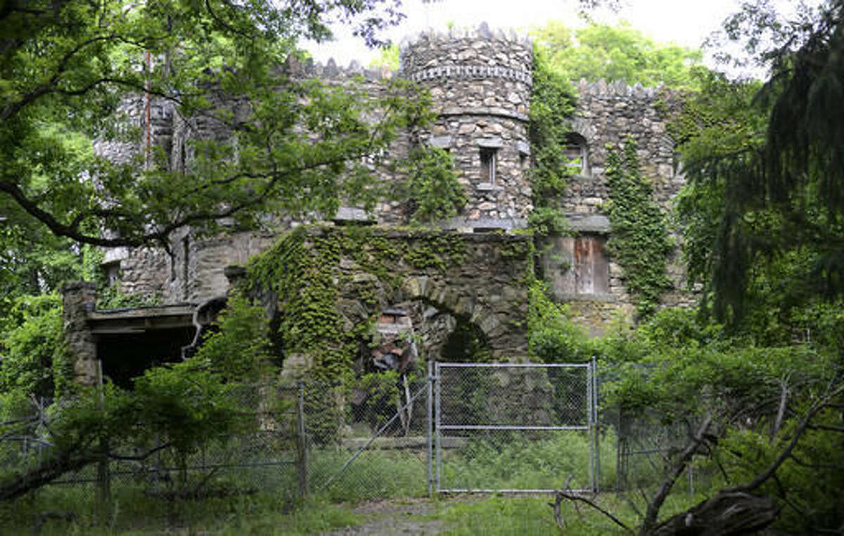 In this Thursday, June 30, 2016 photo, Hearthstone Castle is overgrown with foliage in Danbury, Conn. The city is planning to demolish the castle, a landmark listed on the National Register of Historic Places, that was built in 1899 and has fallen into disrepair. (Tyler Sizemore/Hearst Connecticut Media via AP)