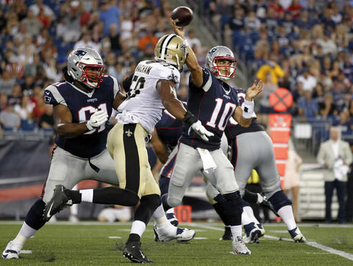 New England Patriots quarterback Jimmy Garoppolo (10) passes as New Orleans Saints defensive end Obum Gwacham (58) rushes during the first half of a preseason NFL football game Thursday, Aug. 11, 2016, in Foxborough, Mass. (AP Photo/Stew Milne)