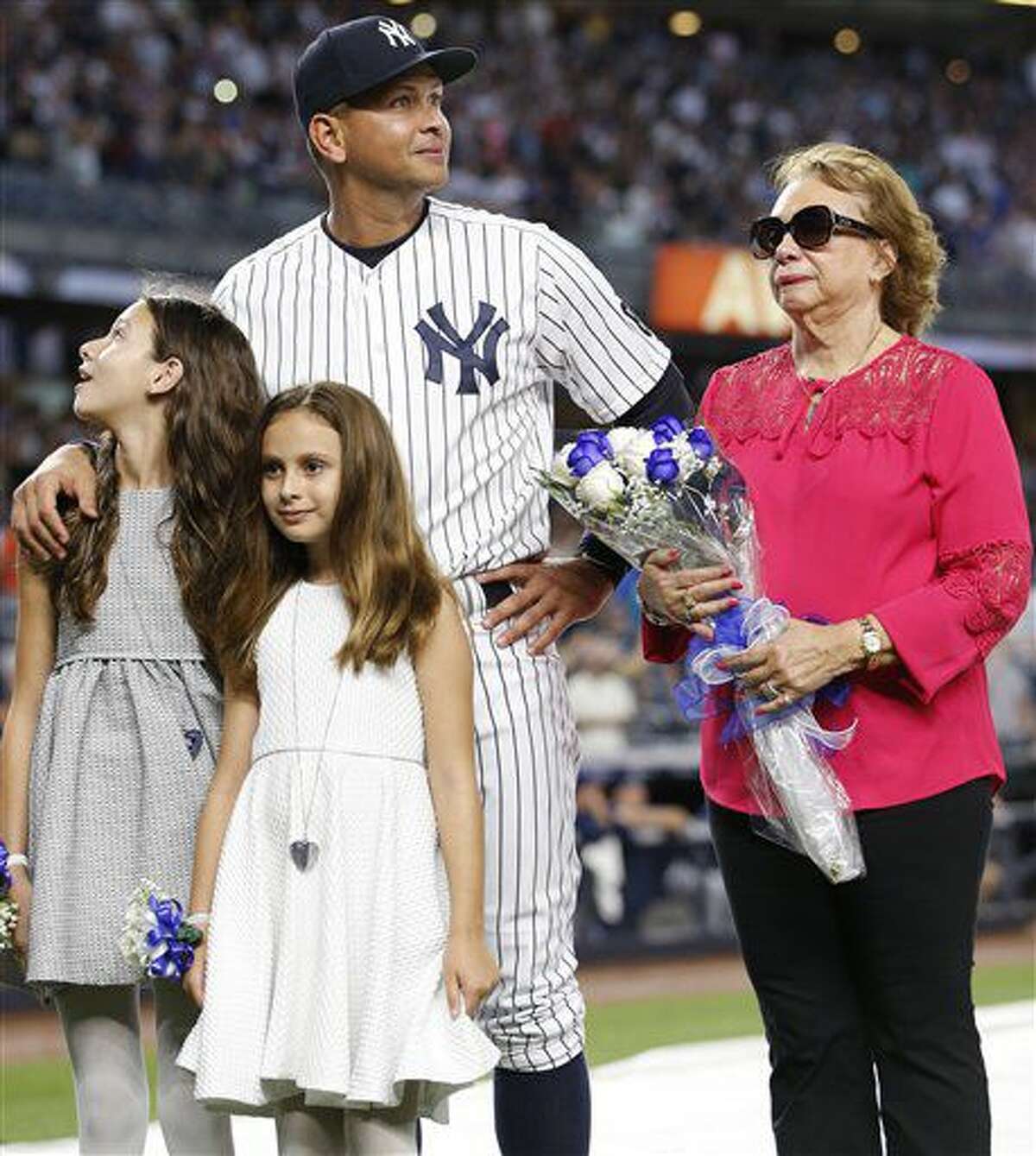 Alex Rodríguez de los Yanquis de Nueva York es acompañado por sus dos hijas, Natasha y Ella, y su madre previo a su último juego con el equipo, el viernes 12 de agosto de 2016. (AP Foto/Kathy Willens)