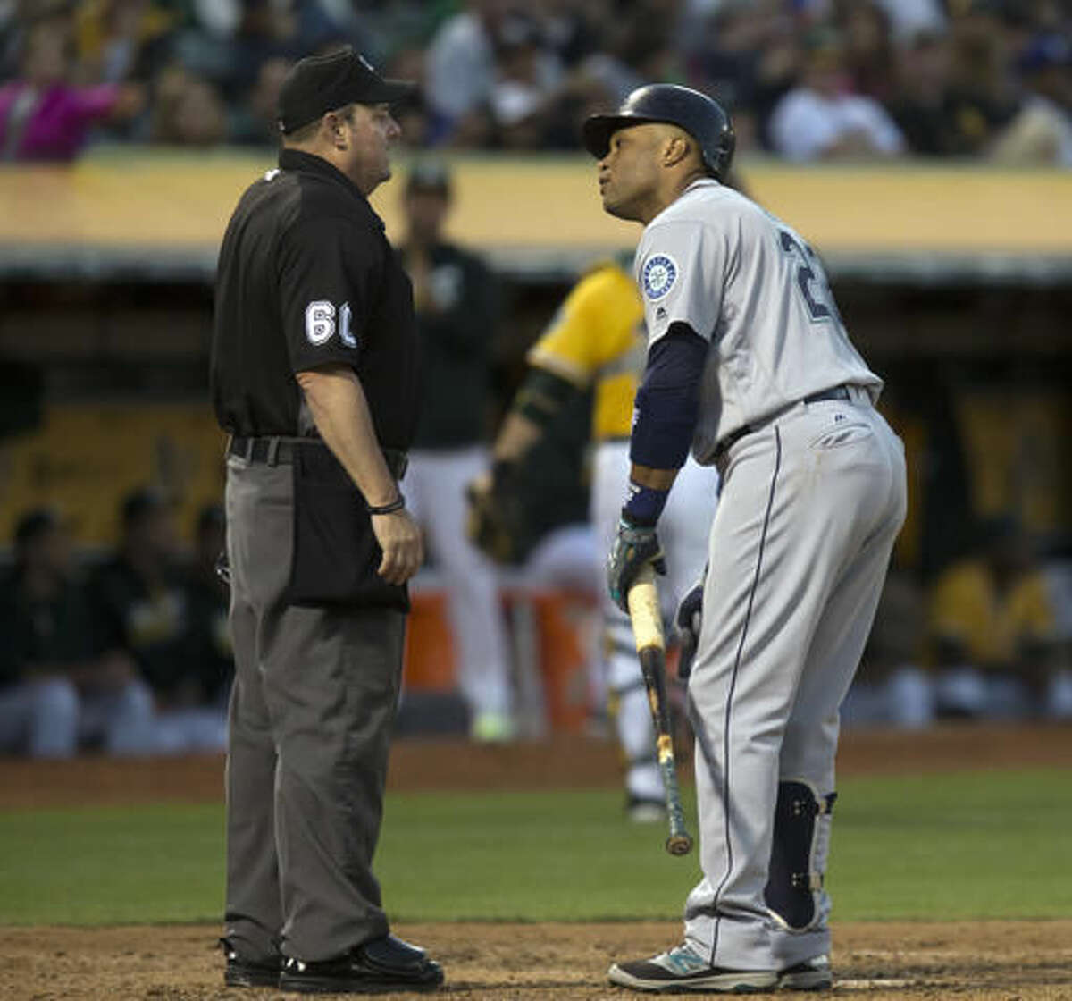 Seattle Mariners' Robinson Cano argues with home plate umpire Marty Foster after being called out on strikes during the fourth inning of a baseball game against the Oakland Athletics, Friday, Aug. 12, 2016, in Oakland, Calif. (AP Photo/D. Ross Cameron)