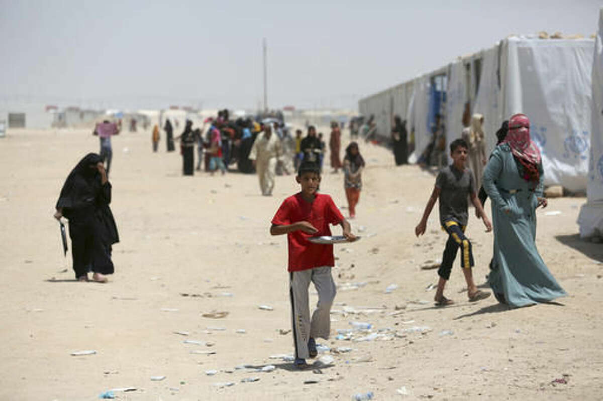 In this photo taken on Saturday, June 25, 2016, Internally displaced civilians, who fled their homes during fighting between Iraqi security forces and Islamic State group, to a camp at Amariyah Fallujah, Iraq. As Iraqi political and military attention shifts north in the fight against the Islamic State group, the military victories that have put Iraqi forces on Mosul's doorstep have left behind shattered cities, towns and communities in Iraq's Sunni heartland. (AP Photo/ Khalid Mohammed)