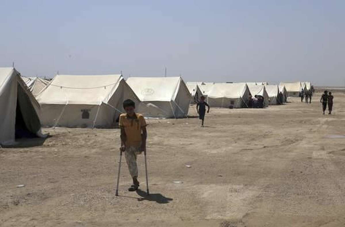 In this photo taken on Saturday, June 25, 2016, internally displaced civilians, who fled their homes during fighting between Iraqi security forces and Islamic State group, to a camp at Amariyah Fallujah, Iraq. As Iraqi political and military attention shifts north in the fight against the Islamic State group, the military victories that have put Iraqi forces on Mosul's doorstep have left behind shattered cities, towns and communities in Iraq's Sunni heartland. (AP Photo/ Khalid Mohammed)