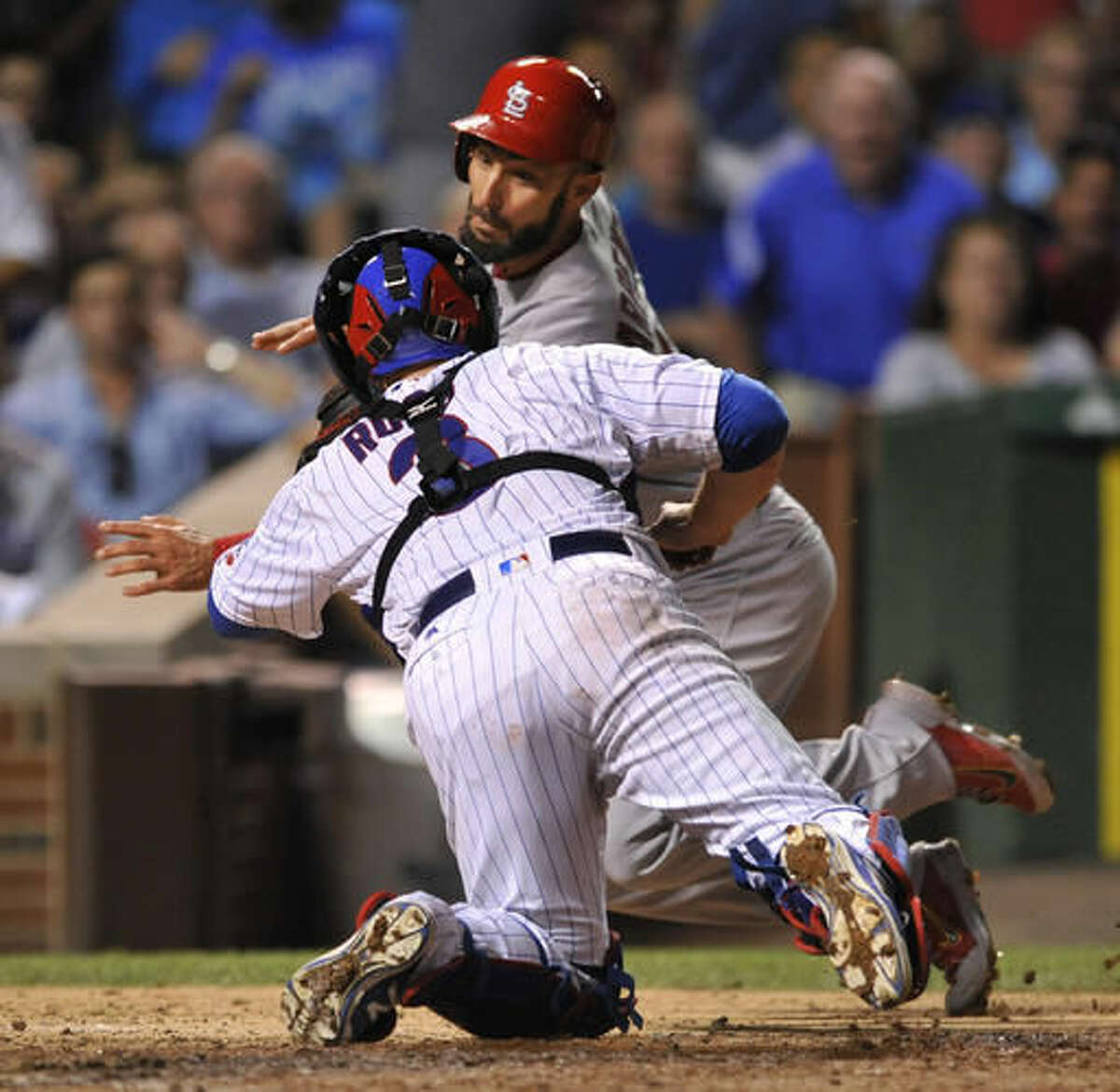 Chicago Cubs catcher David Ross tags out St. Louis Cardinals' Matt Carpenter at home plate during the seventh inning of a baseball game Thursday, Aug. 11, 2016, in Chicago. (AP Photo/Paul Beaty)