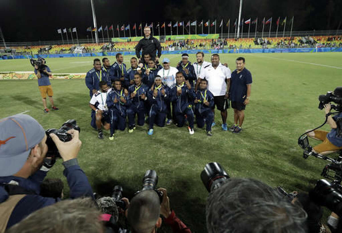 Fiji's rugby team poses after winning their country's first Olympic medal after taking gold by defeating Britain in mens rugby sevens at the 2016 Summer Olympics in Rio de Janeiro, Brazil, Thursday, Aug. 11, 2016. (AP Photo/Robert F. Bukaty)