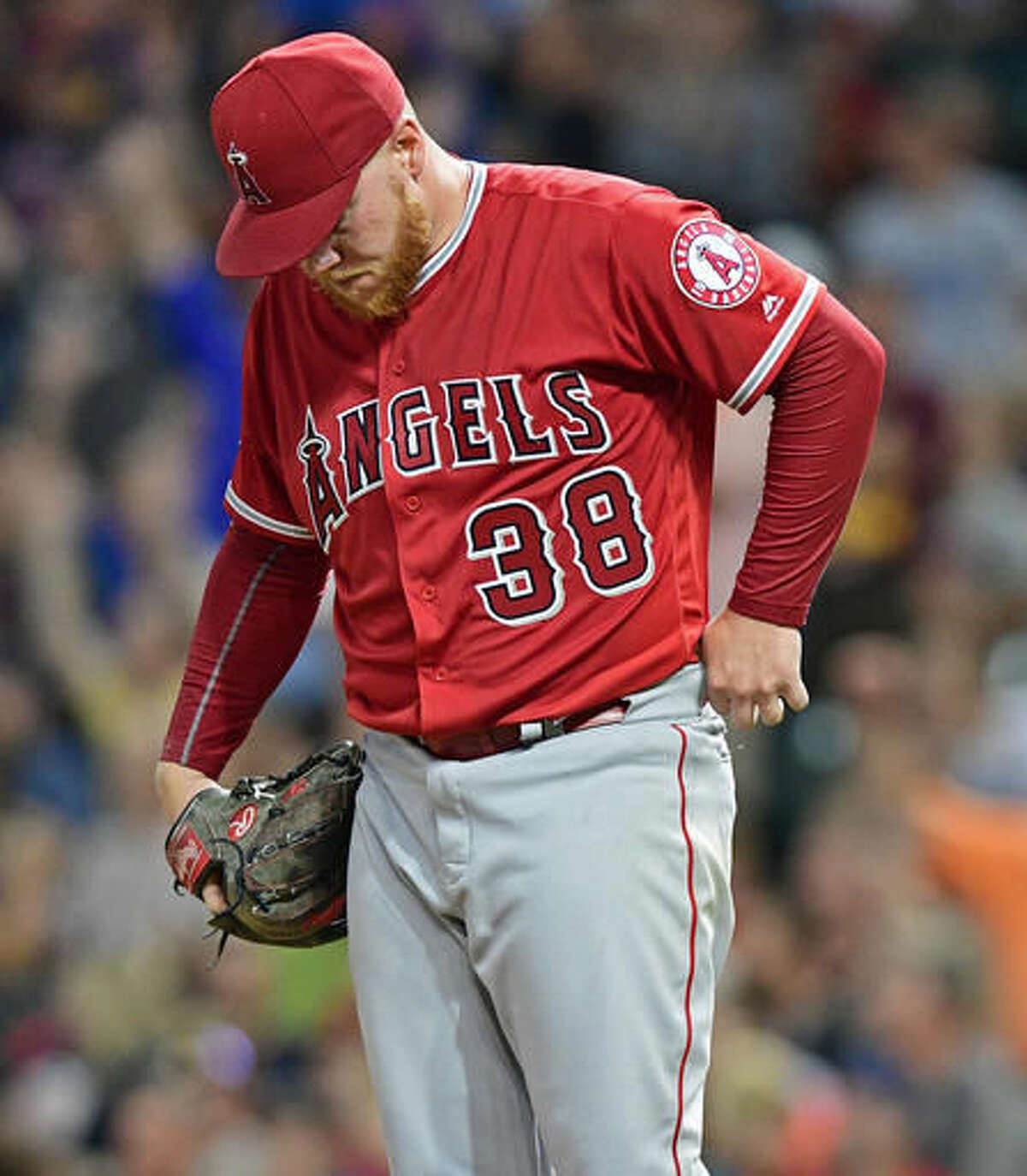 Los Angeles Angels relief pitcher Brett Oberholtzer hangs his head after a three-run home run by Cleveland Indians' Mike Napoli during the fifth inning of a baseball game, Thursday, Aug. 11, 2016, in Cleveland. (AP Photo/David Dermer)