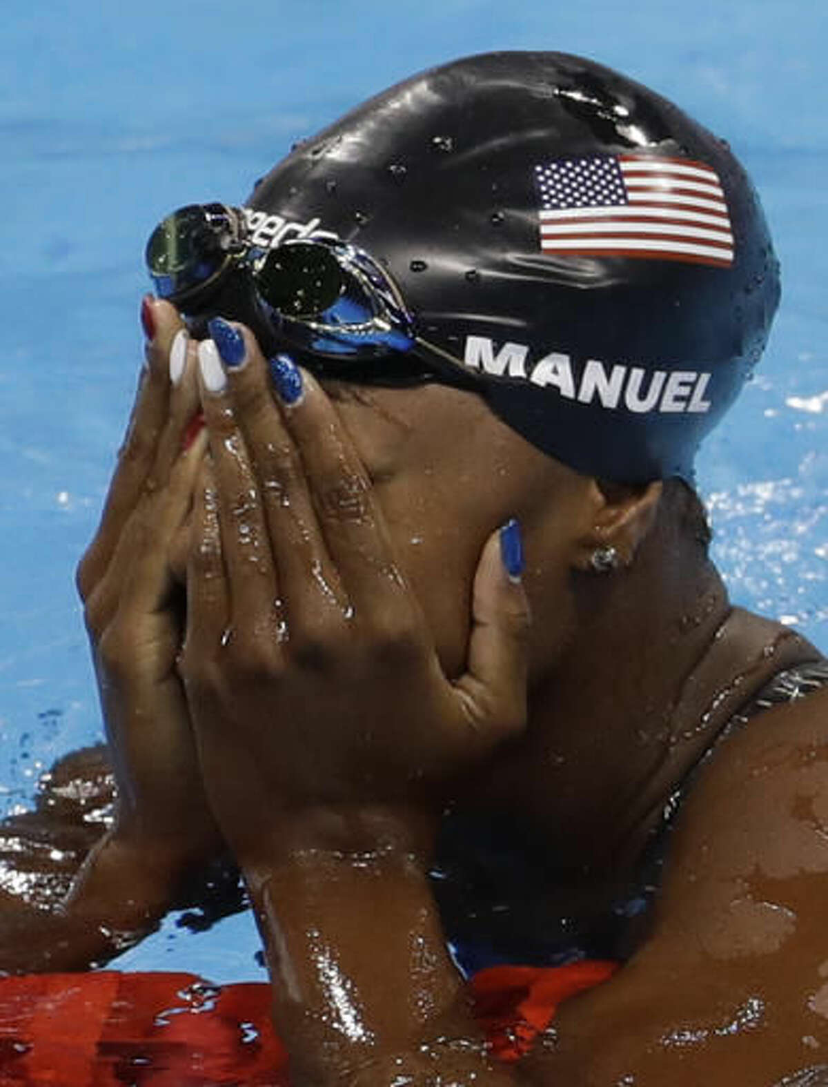 United States' Simone Manuel wins the gold medal setting a new olympic record in the women's 100-meter freestyle during the swimming competitions at the 2016 Summer Olympics, Thursday, Aug. 11, 2016, in Rio de Janeiro, Brazil. (AP Photo/Natacha Pisarenko)