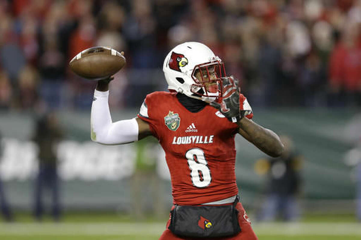 FILE - In this Dec. 30, 2015, file photo, Louisville quarterback Lamar Jackson passes against Texas A&M in the first half of the Music City Bowl NCAA college football game, in Nashville, Tenn. (AP Photo/Mark Humphrey, File)