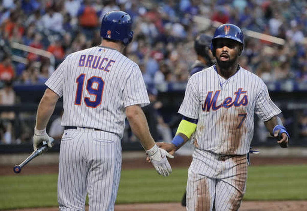 New York Mets'Jose Reyes (7) is greeted by Jay Bruce (19) after scoring on a base hit by Neil Walker against the San Diego Padres during the first inning of a baseball game, Saturday, Aug. 13, 2016, in New York. (AP Photo/Julie Jacobson)