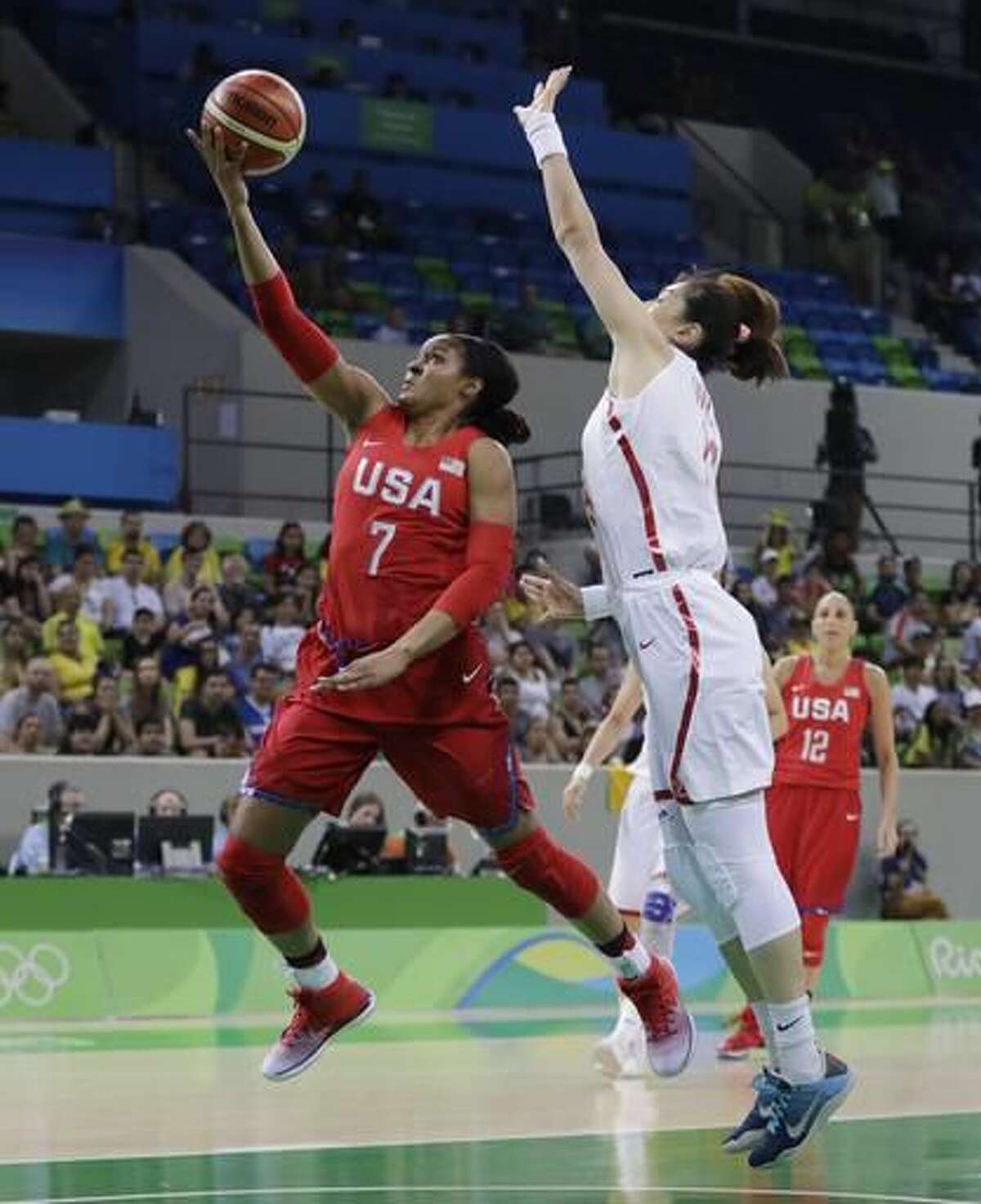 United States forward Maya Moore (7) makes a layup defended by China center Mengran Sun during the first half of a women's basketball game at the Youth Center at the 2016 Summer Olympics in Rio de Janeiro, Brazil, Sunday, Aug. 14, 2016. (AP Photo/Carlos Osorio)
