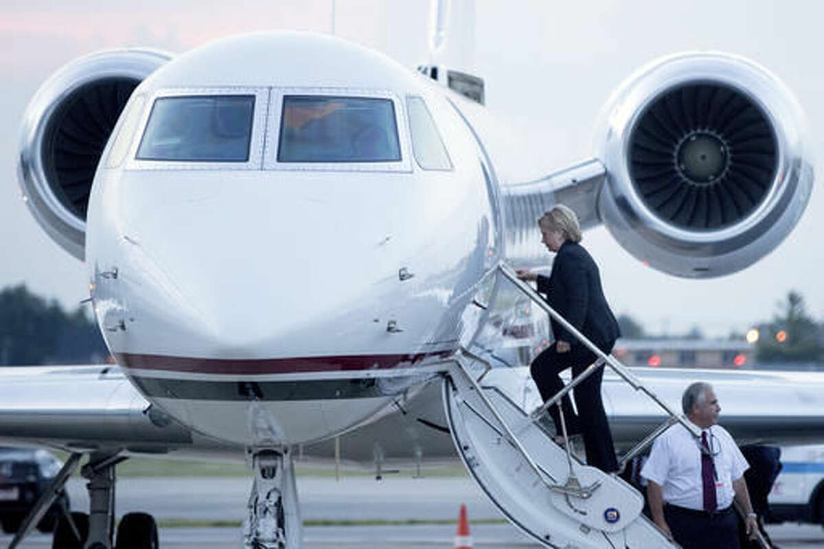 Democratic presidential candidate Hillary Clinton boards a plane at Chicago Midway International Airport, in Chicago, Thursday, Aug. 11, 2016, to travel to Westchester, N.Y. Clinton gave a speech on the economy after touring Futuramic Tool & Engineering in Warren, Mich., and attended a fundraiser in Chicago. (AP Photo/Andrew Harnik)