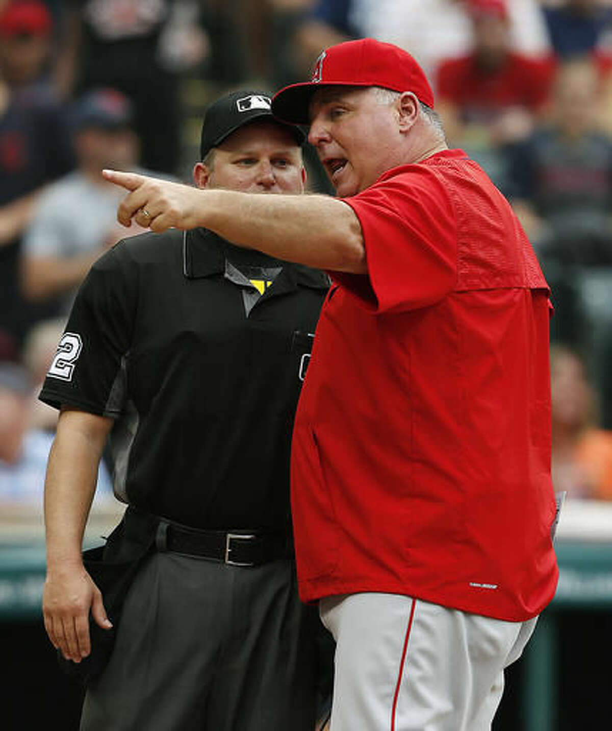 Los Angeles Angels manager Mike Scioscia, right, argues home plate umpire Clint Fagan after Fagan ejected Albert Pujols during the eighth inning of a baseball game against the Cleveland Indians, Sunday, Aug. 14, 2016, in Cleveland. (AP Photo/Ron Schwane)