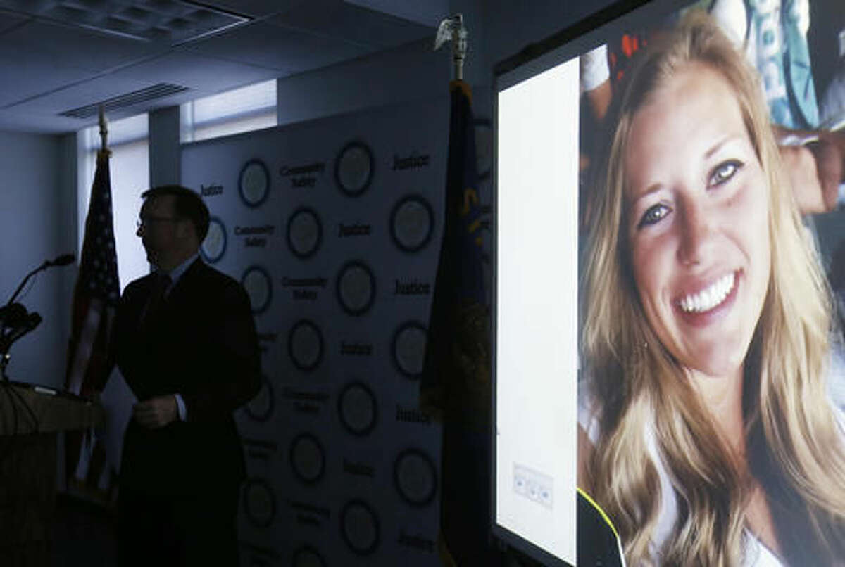 FILE--In this July 26, 2016, file photo, a picture of Kaylee Sawyer is displayed on a screen as Deschutes County District Attorney John Hummel speaks during a press conference on at the Deschutes County Courthouse in Bend, Ore. The murder of Kaylee Sawyer followed by a string of other crimes leading from Oregon through California allegedly committed by Central Oregon Community College safety officer Edwin Lara has this scenic mountain town deeply shaken. (Joe Kline/The Bulletin via AP, file)
