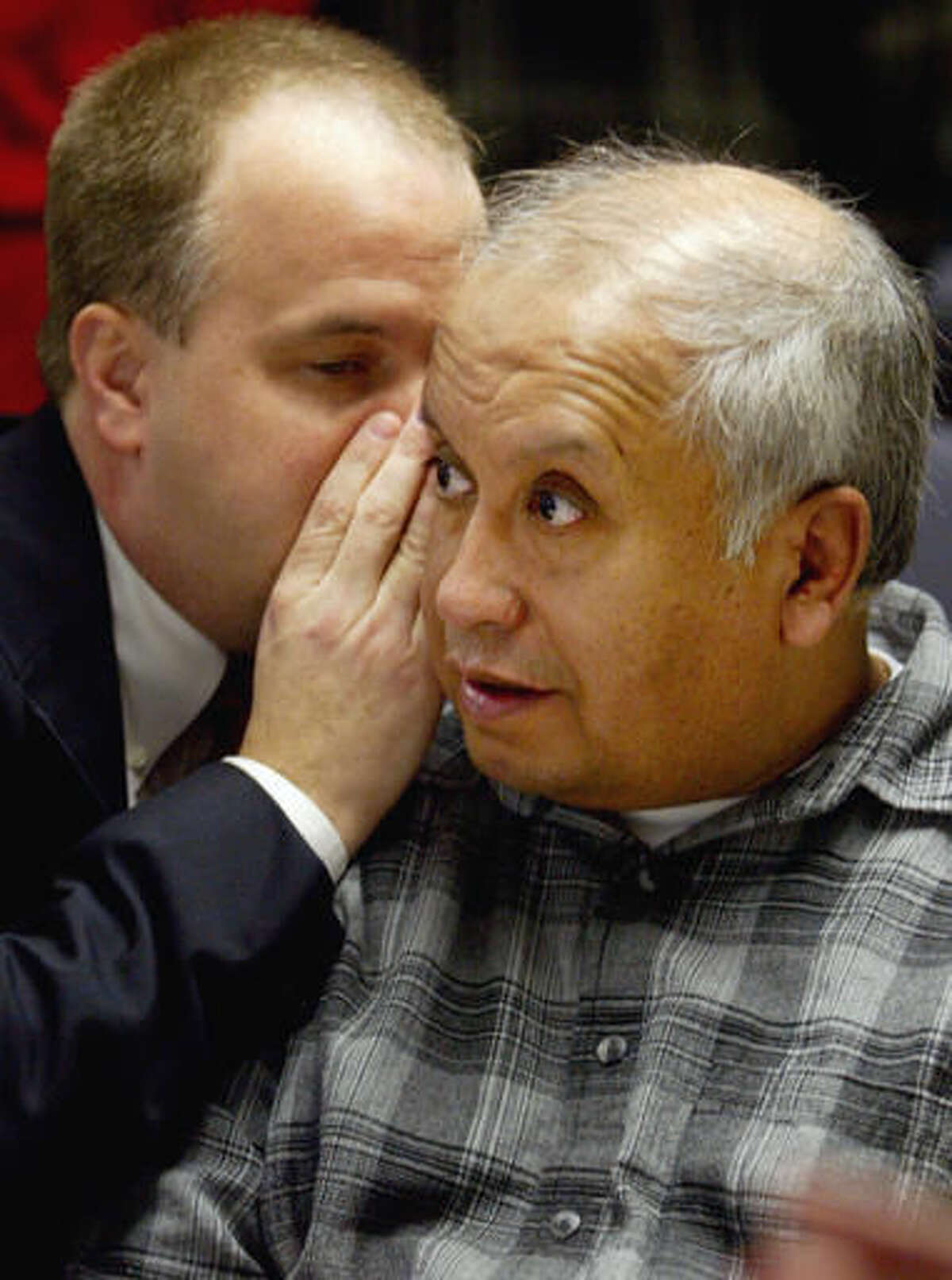 FILE - In this March 5, 2004 file photo, Alfonso Rodriguez Jr., of Crookston, Minn., listens as his attorney David Dusek, whispers to him during a preliminary hearing in Grand Forks, N.D. Rodriguez was convicted in 2005 of kidnapping and killing University of North Dakota student Dru Sjodin. A federal judge on Tuesday, Aug. 16, 2016, pushed back two hearings in the Rodriguez's final death penalty appeal so Rodriguez's new defense team could catch up on evidence. (Jackie Lorentz/Grand Forks Herald via AP, Pool, File)