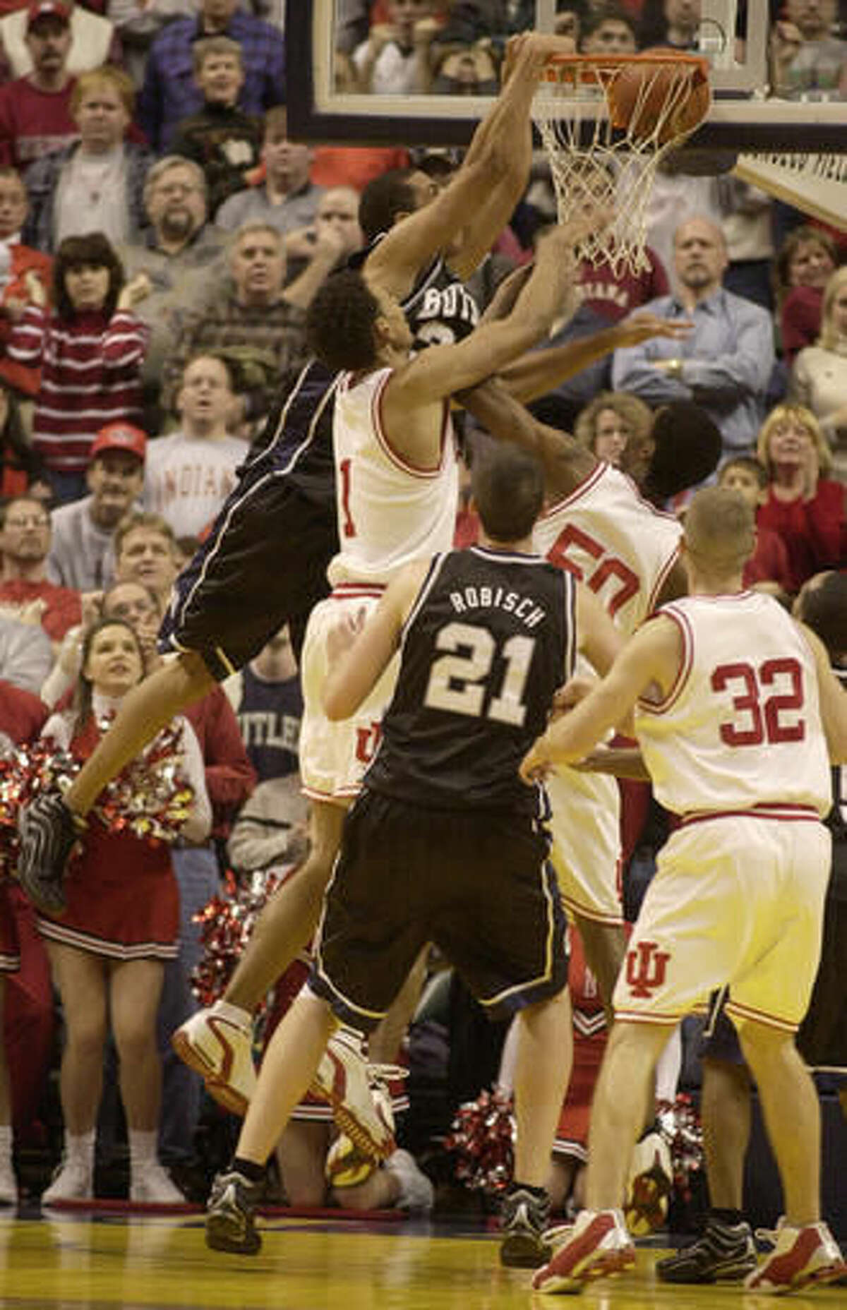FILE - In this Dec. 29, 2001, file photo, Butler forward Joel Cornette (33) leaps over a crowded middle and slams home the game-winner off a rebound to give the 23rd-ranked Bulldogs a 66-64 victory over Indiana in the Hoosier Classic championship game in Indianapolis. Cornette, who helped Butler make the transition from a traditional mid-major program into a surprising power in college basketball, died Tuesday, Aug. 16, 2016, in a Chicago apartment. He was 35. (AP Photo/Darron Cummings, FIle)