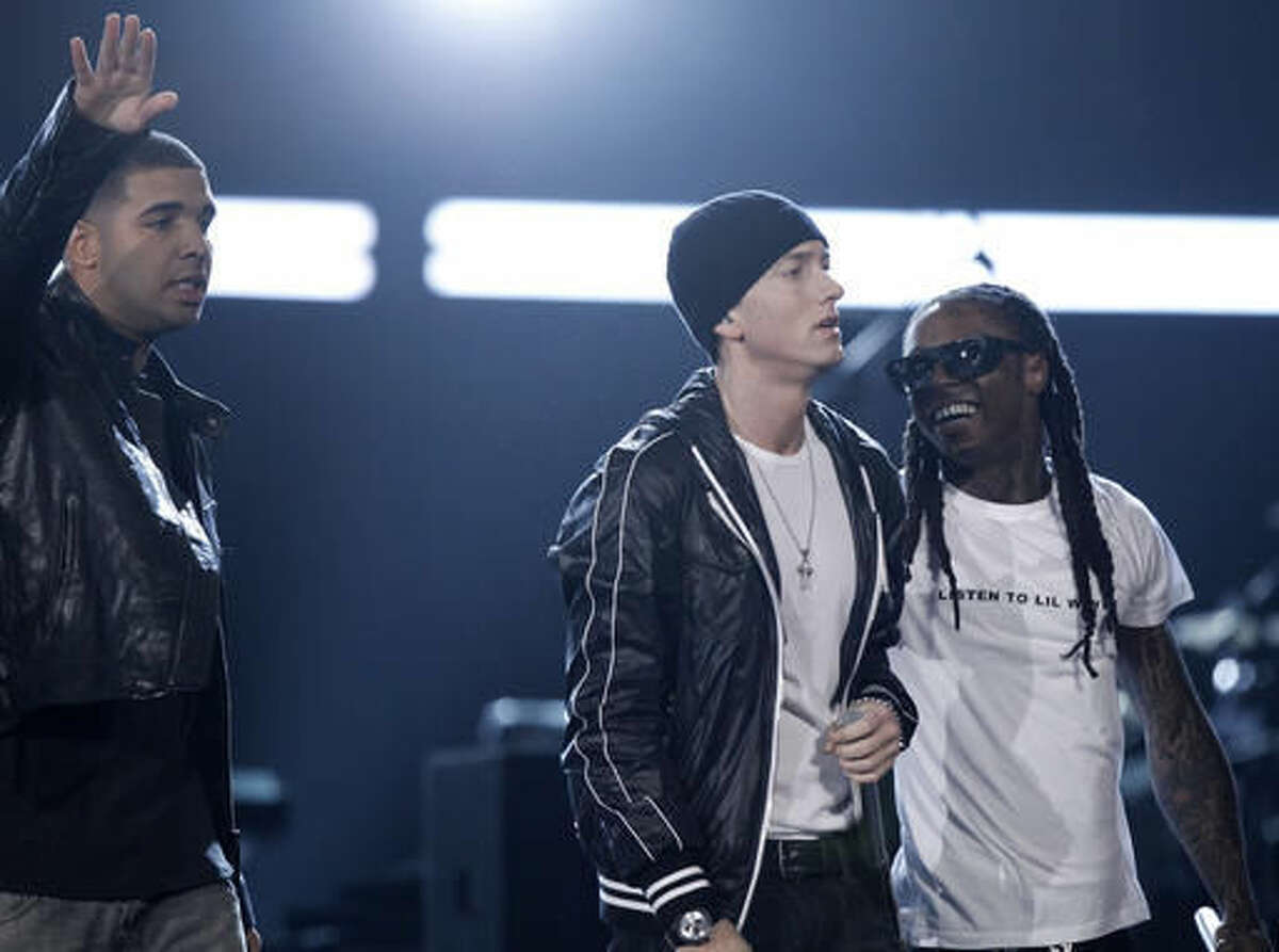 FILE - In this Jan. 31, 2010, file photo, Drake, Eminem, and Lil Wayne perform at the Grammy Awards in Los Angeles. Eminem joined Drake on stage at Drake's August 16, 2016, show at Joe Louis Arena in Eminem's native Detroit. (AP Photo/Matt Sayles, File)