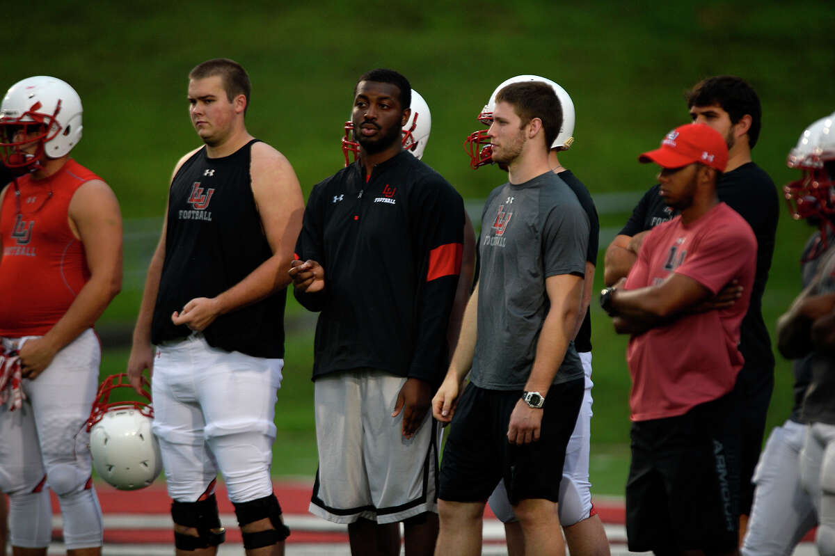 Justin Brock, a graduate assistant with Lamar's football team, watches the offensive line during a rainy practice on Monday evening. Photo taken Monday 8/15/16 Ryan Pelham/The Enterprise
