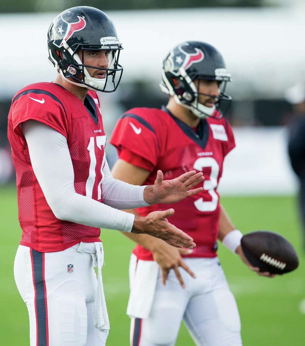 Houston Texans quarterbacks Brock Osweiler (17) and Tom Savage (3) warm up during a joint training camp practice between the Texans and Saints at Houston Methodist Training Center on Thursday, Aug. 18, 2016, in Houston.