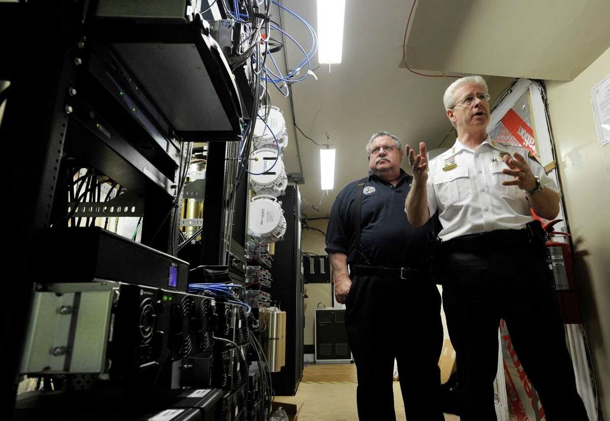 Dick Aarons, left, duputy emergency manager for Ridgefield and Ridgefield Police Chief John Roche, talk about a project nearing completion that replaces the town's emergency communications radio system, Thursday, August 18, 2016.