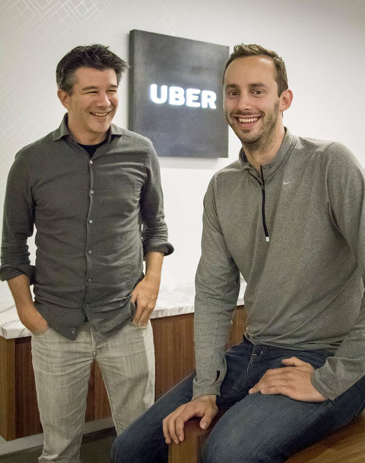 Uber CEO Travis Kalanick, left, and Anthony Levandowski, co-founder of Otto, pose for a photo in the lobby of Uber headquarters, Thursday, Aug. 18, 2016, in San Francisco.