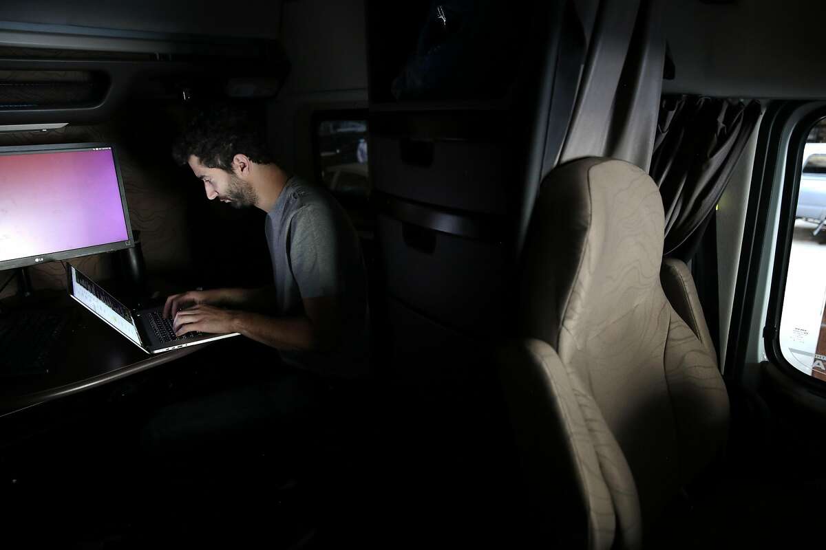Software engineer Eyal Cohen of Otto, led by 15 former Google engineers, codes in the cab of one of the company�s big rig trucks in San Francisco, May 16, 2016. The engineers believe that automating trucks rather than passenger vehicles could be more palatable financially and to regulators. (Ramin Rahimian/The New York Times)