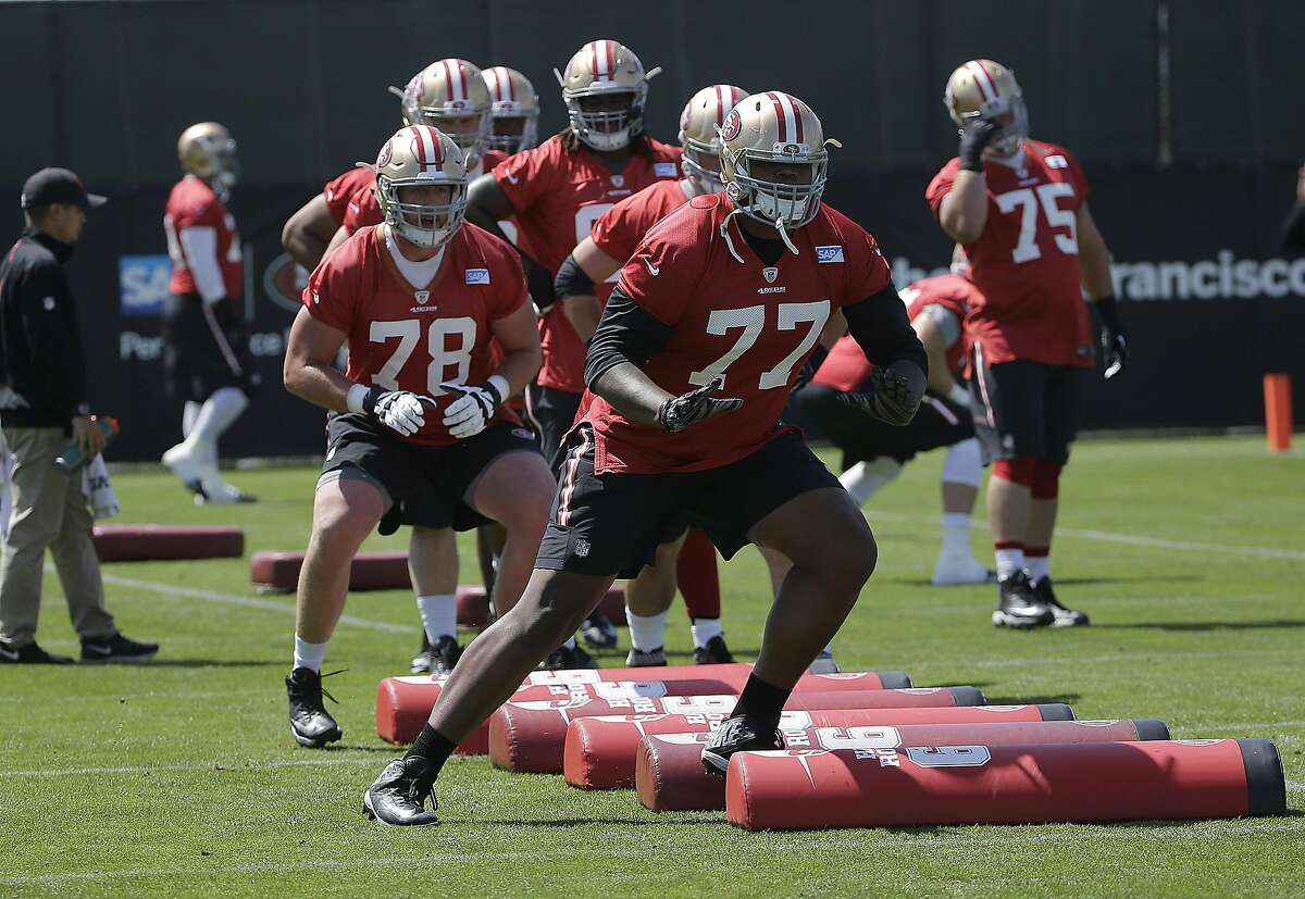 San Francisco 49ers' Trent Brown (77) and John Theus (78) perform a drill at an NFL football practice in Santa Clara, Wednesday, June 8, 2016.