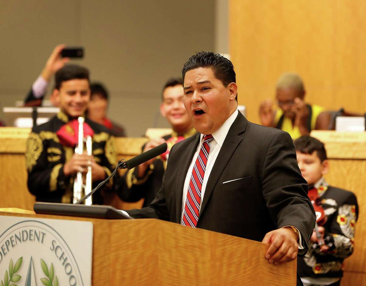 Richard Carranza sings with members of the Northside High School mariachi group who were present during the Houston school board meeting to officially hire him as the superintendent, Thursday, Aug. 18, 2016, in Houston.