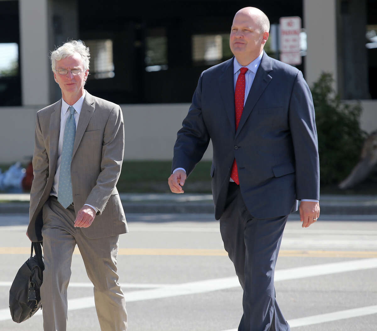 Mikal Watts, right, walks to the federal courthouse in Gulfport, Miss. with his attorney Robert McDuff for an initial appearance before U.S. Magistrate John Gargiulo on Thursday, Oct. 29, 2015. Mikal Watts, a Texas lawyer, his brother and a second employee of his law firm are among seven people accused of faking more than 40,000 damage claims after the BP oil spill in 2010, federal prosecutors said Thursday. (Amanda McCoy/The Sun Herald via AP) LOCAL TELEVISION OUT; MANDATORY CREDIT: MISSISSIPPI PRESS OUT; LOCAL TELEVISION OUT WLOX, LOCAL ONLINE OUT; GULFLIVE.COM OUT
